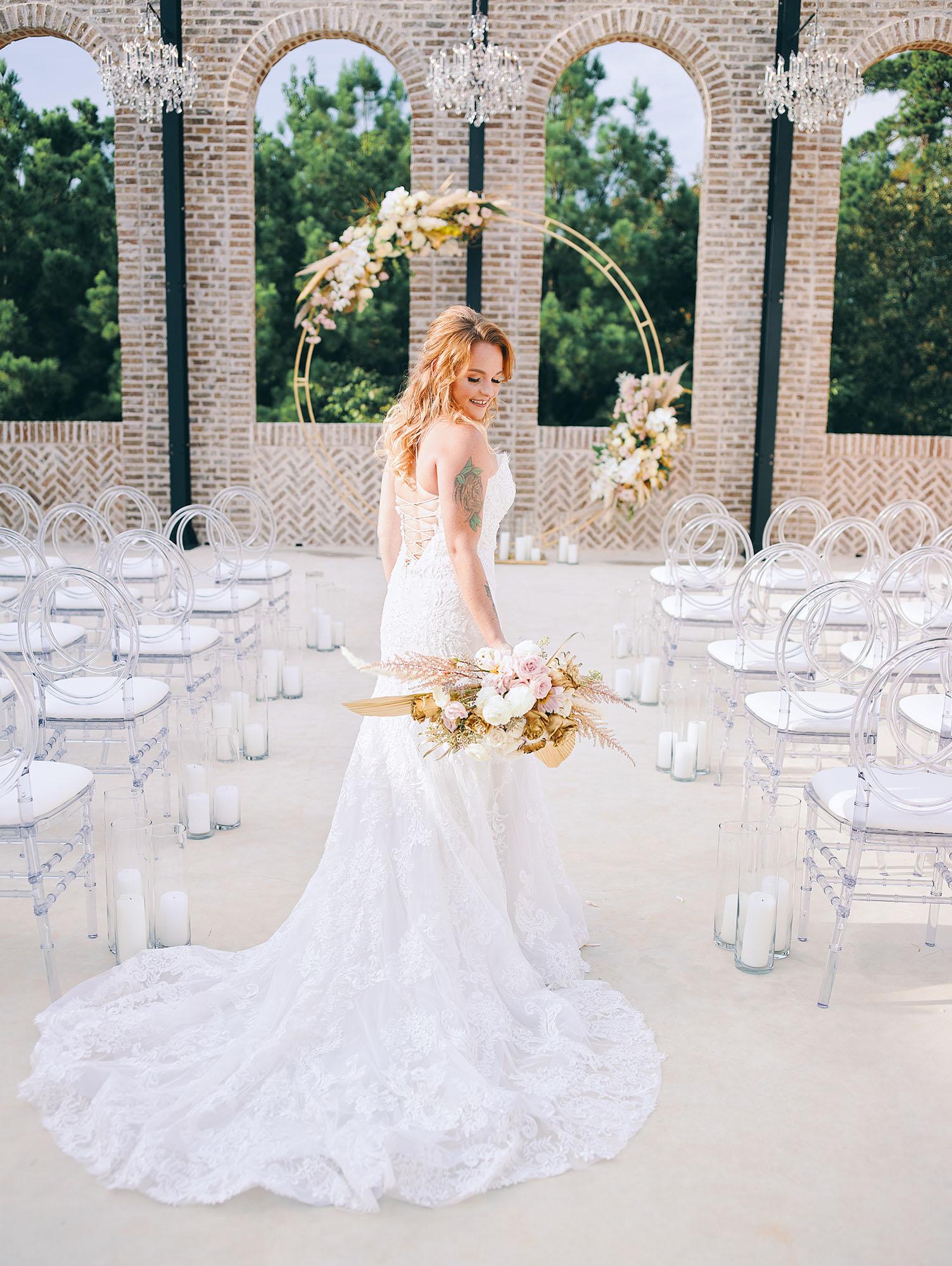 outdoor wedding ceremony decor - wedding dress - bouquet - ghost chairs