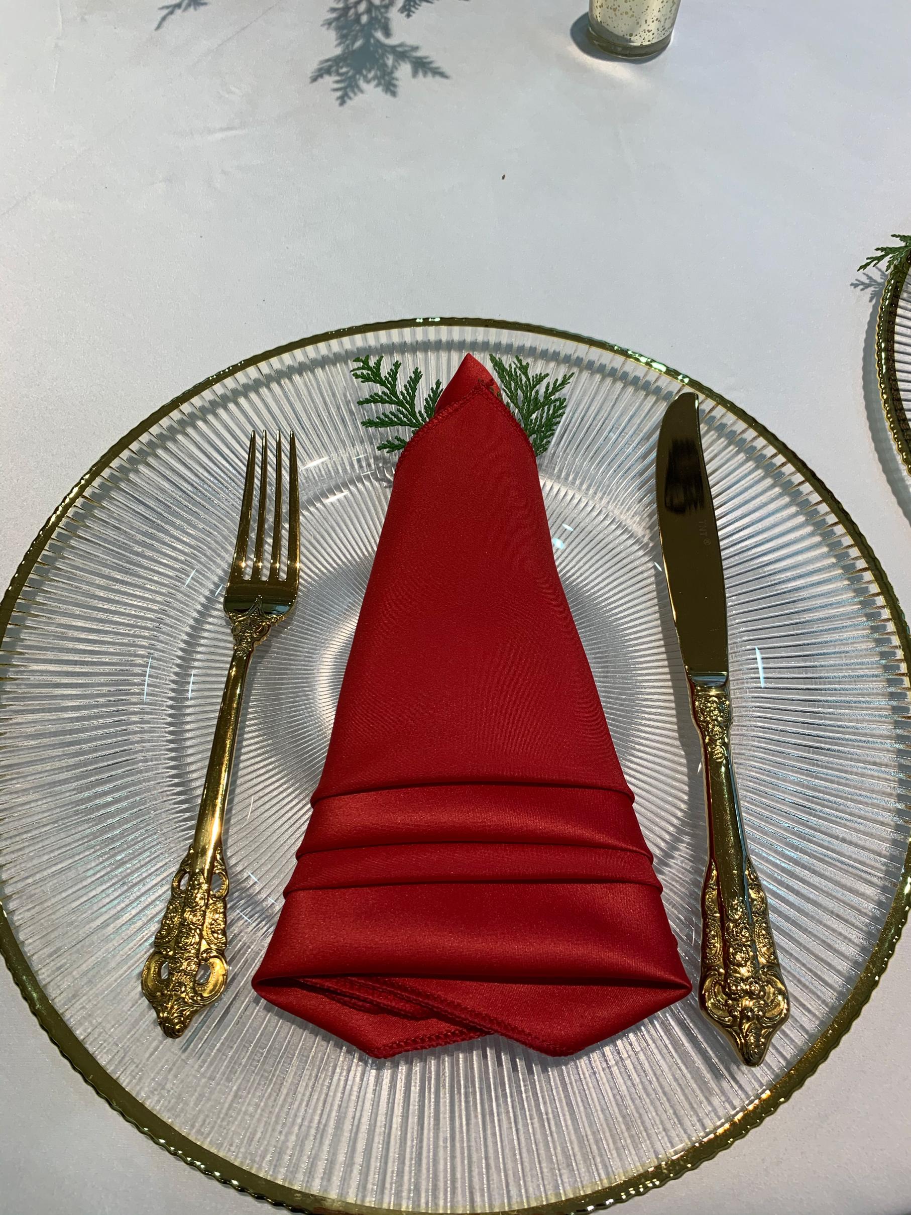 We were honored to host the Jaguar car dealership holiday party. Their corporate event decor featured gold chairs, black chairs, gold chargers, a photo wall, and red linens.