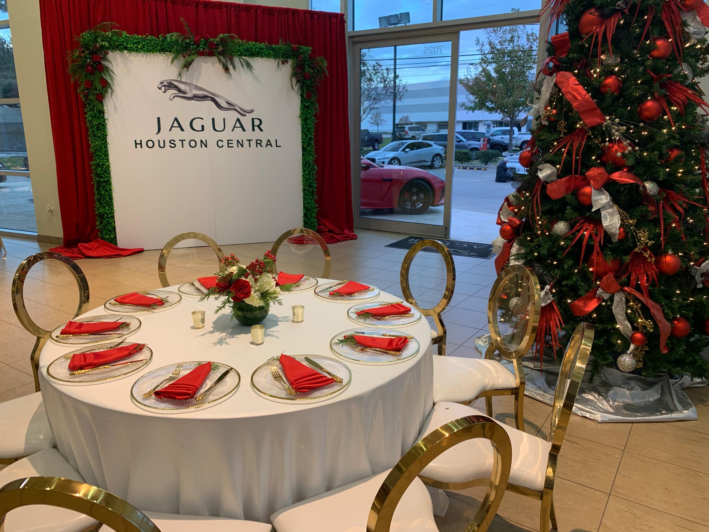 jaguar holiday party with red and white flowers