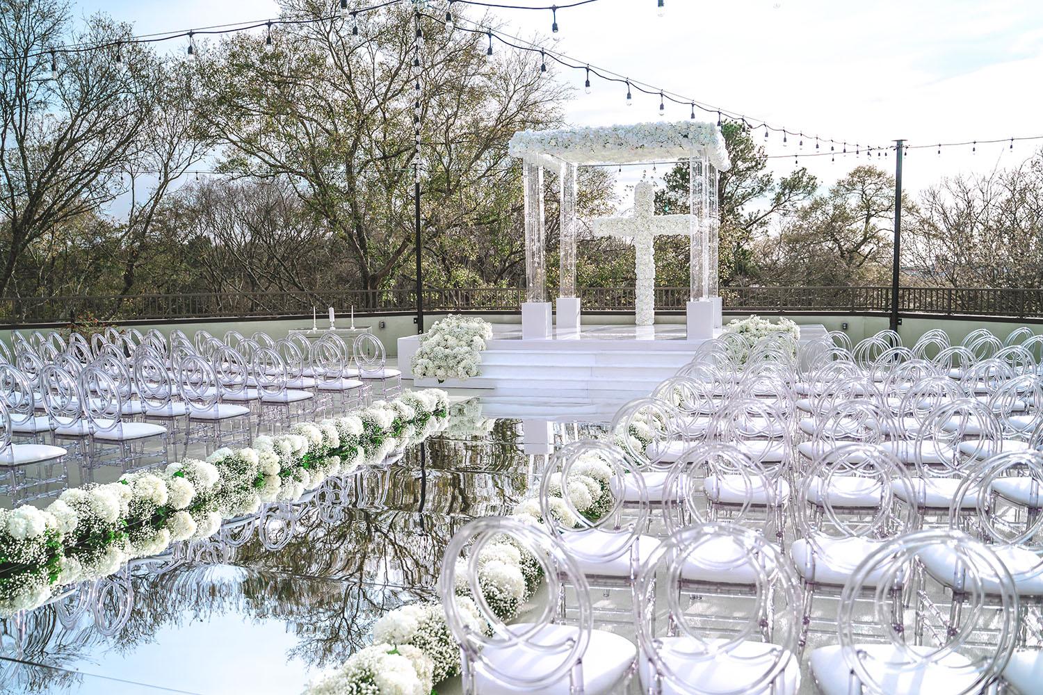 mirror aisle, royal luxury events, ceremony decor, ivory flowers, canopy, cross, clear chairs