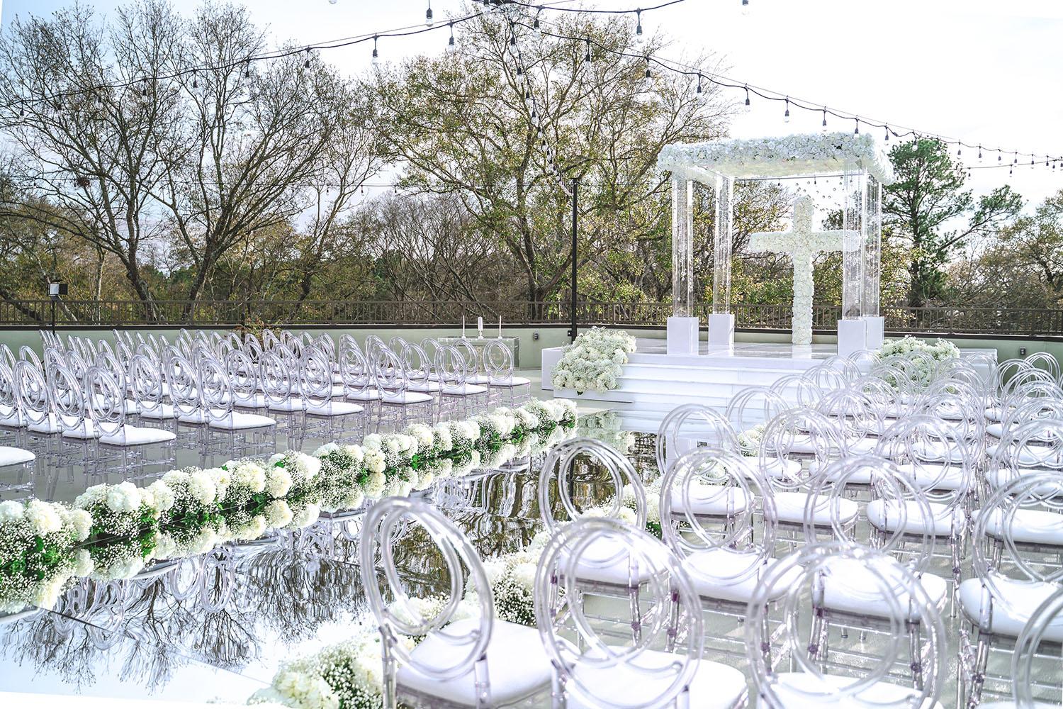 mirror aisle, royal luxury events, ceremony decor, ivory flowers, canopy, cross, clear chairs