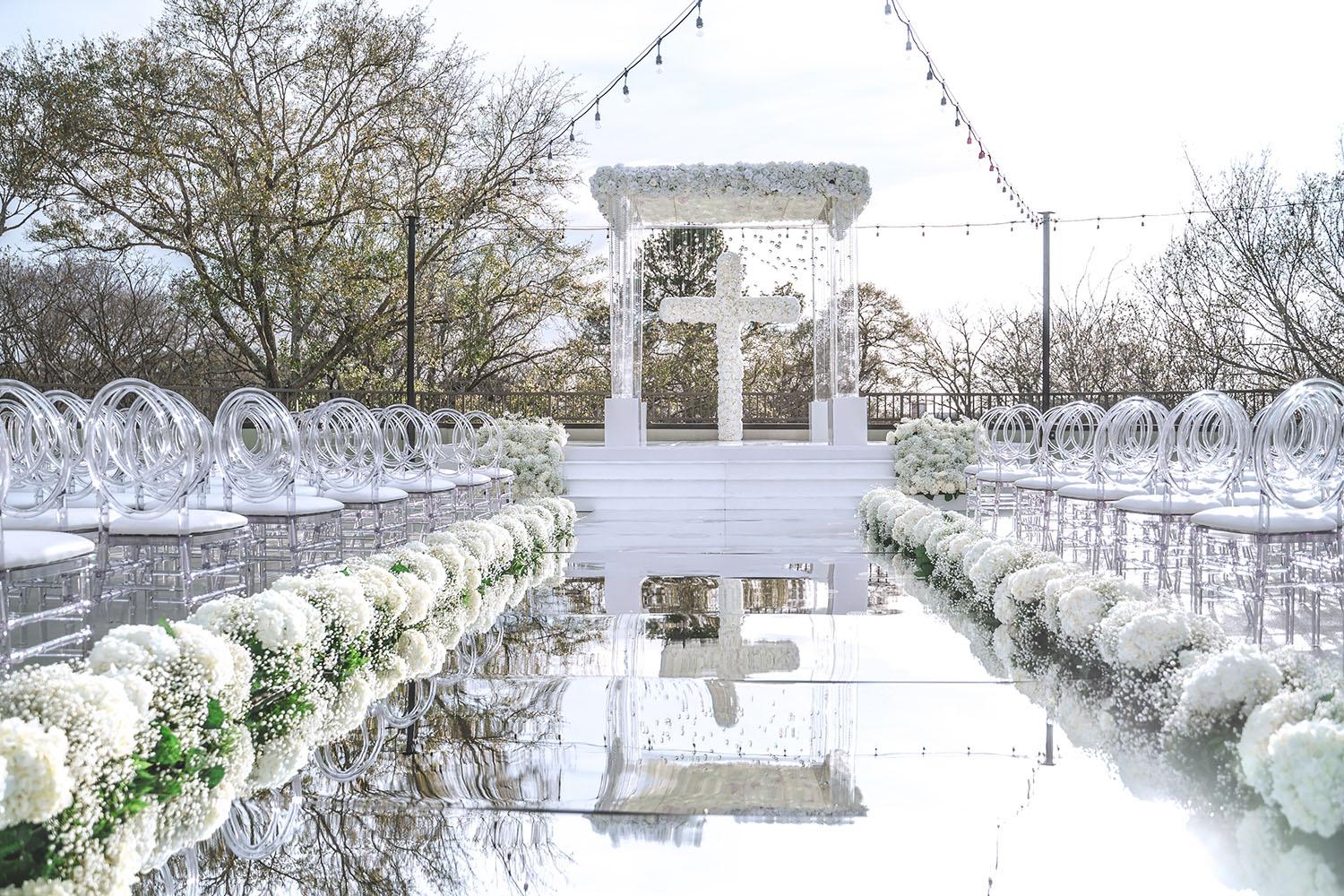 mirror aisle, royal luxury events, ceremony decor, ivory flowers, canopy, cross, clear chairs