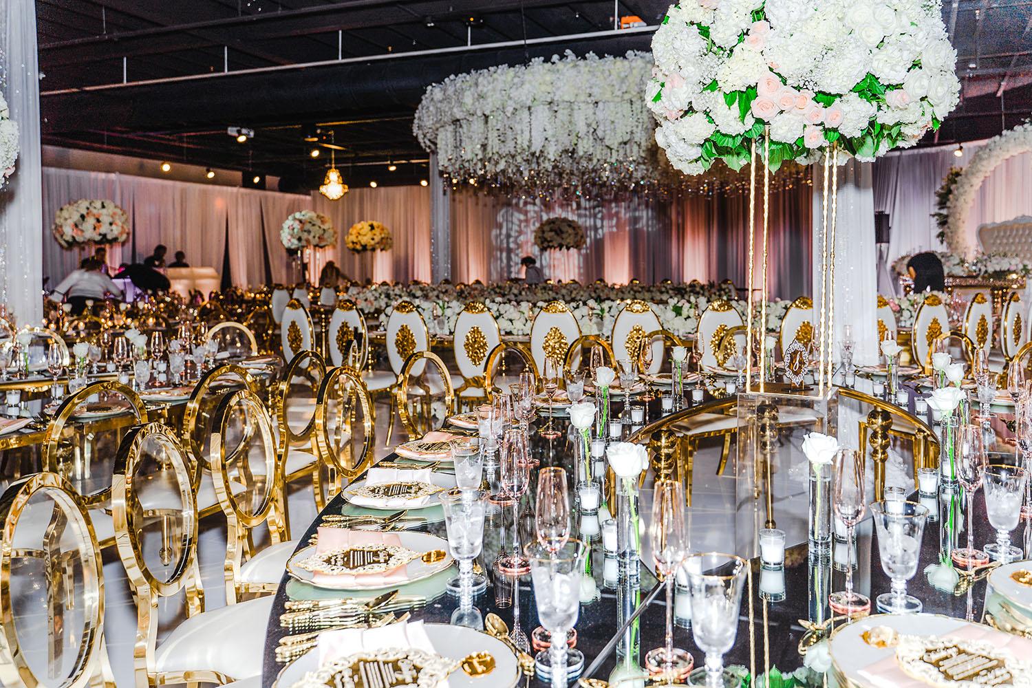 ceiling decor, cake drop, royal luxury, wedding reception decor, gold chairs, mirror tables, chargers, tableware, circle arch