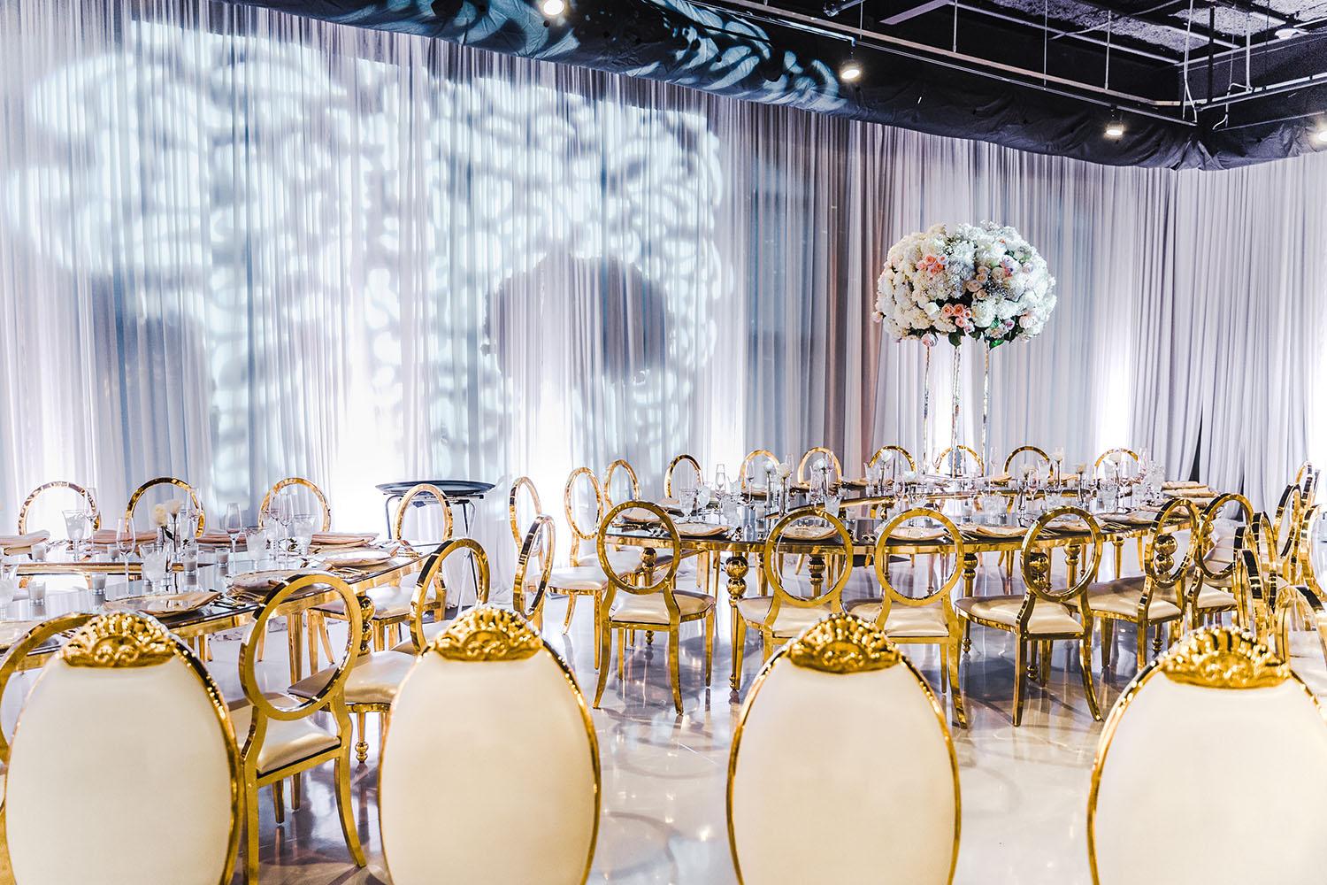 ceiling decor, cake drop, royal luxury, wedding reception decor, gold chairs, mirror tables, chargers, tableware, circle arch