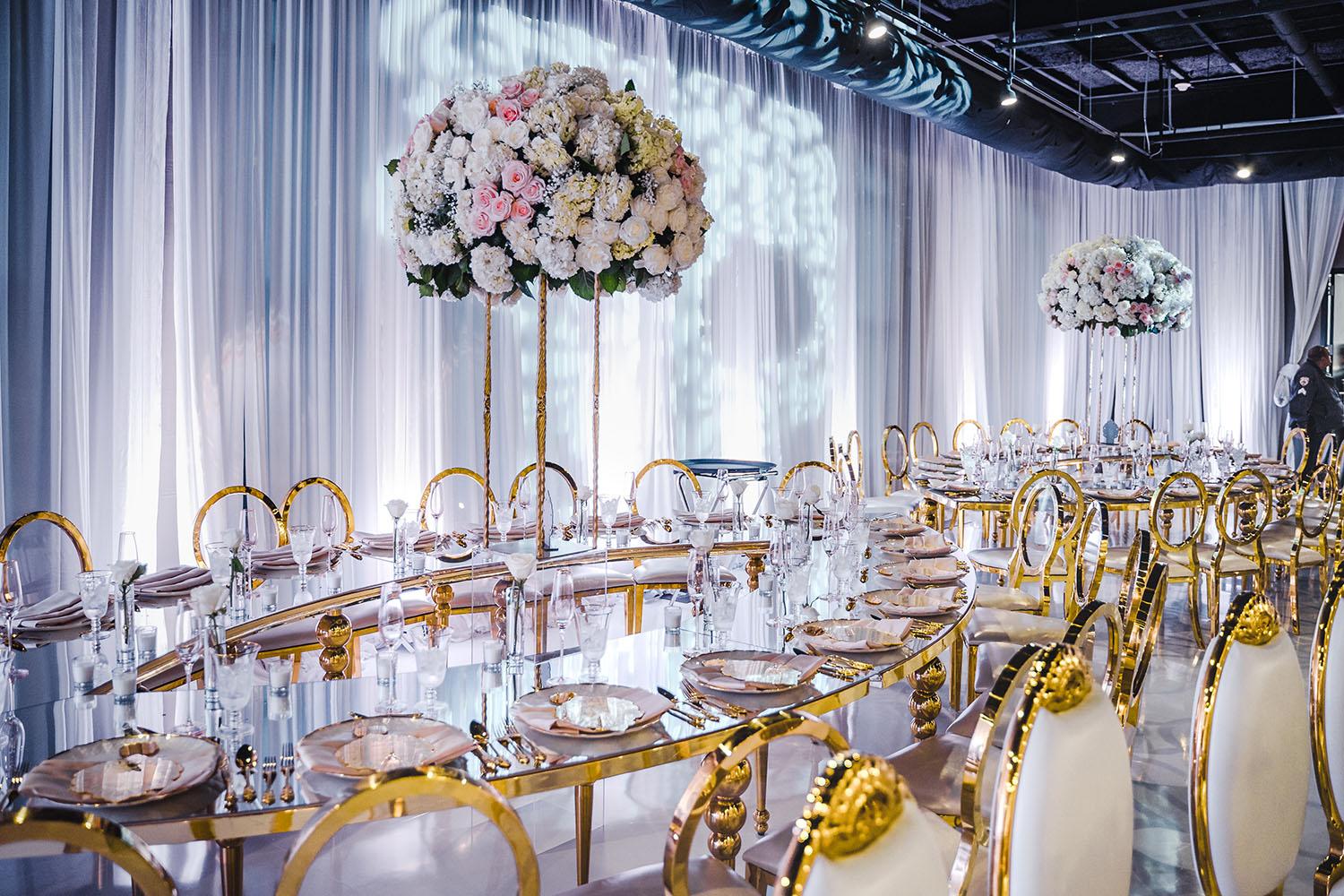 ceiling decor, cake drop, royal luxury, wedding reception decor, gold chairs, mirror tables, chargers, tableware, circle arch