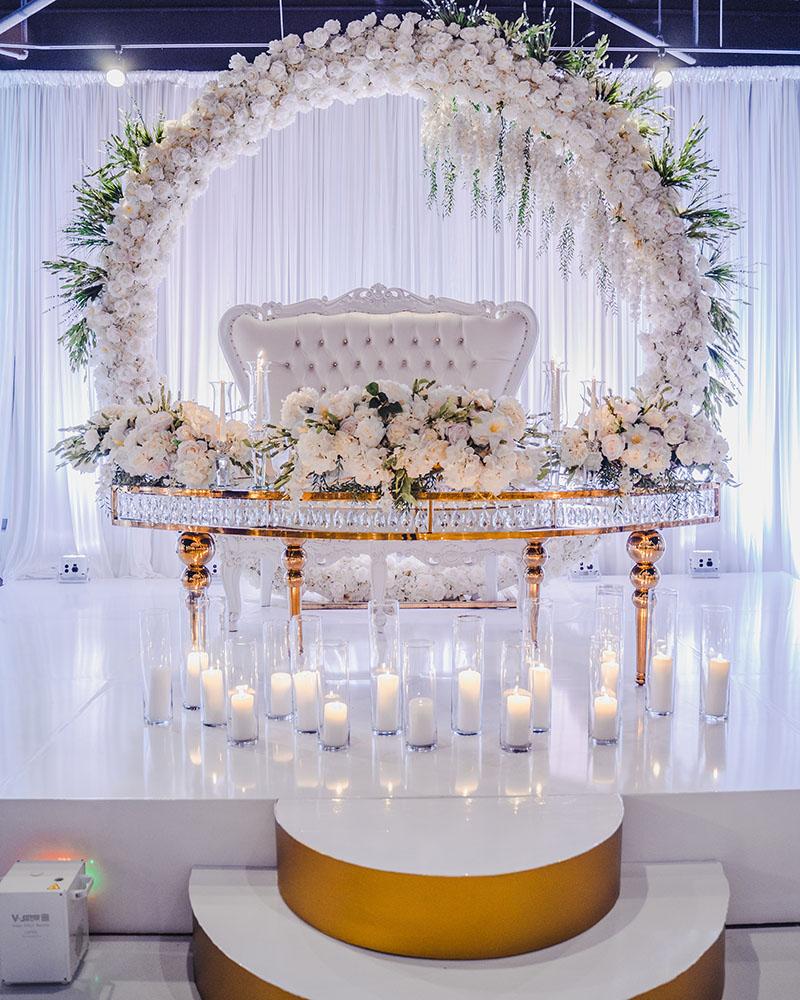 ceiling decor, cake drop, royal luxury, wedding reception decor, gold chairs, mirror tables, chargers, tableware, circle arch