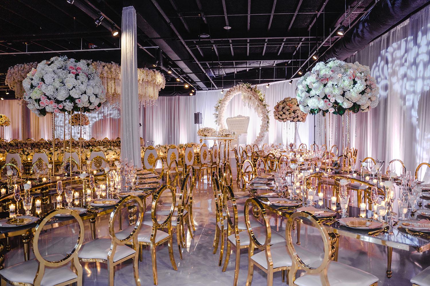 ceiling decor, cake drop, royal luxury, wedding reception decor, gold chairs, mirror tables, chargers, tableware, circle arch