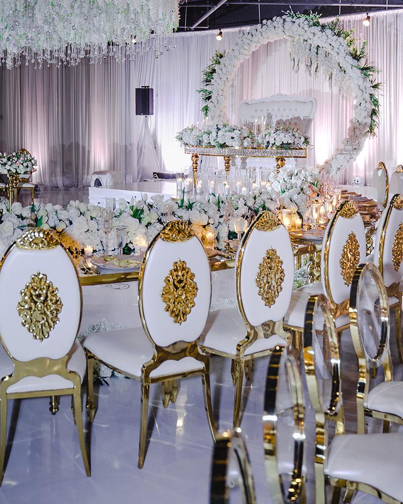 ceiling decor, cake drop, royal luxury, wedding reception decor, gold chairs, mirror tables, chargers, tableware, circle arch