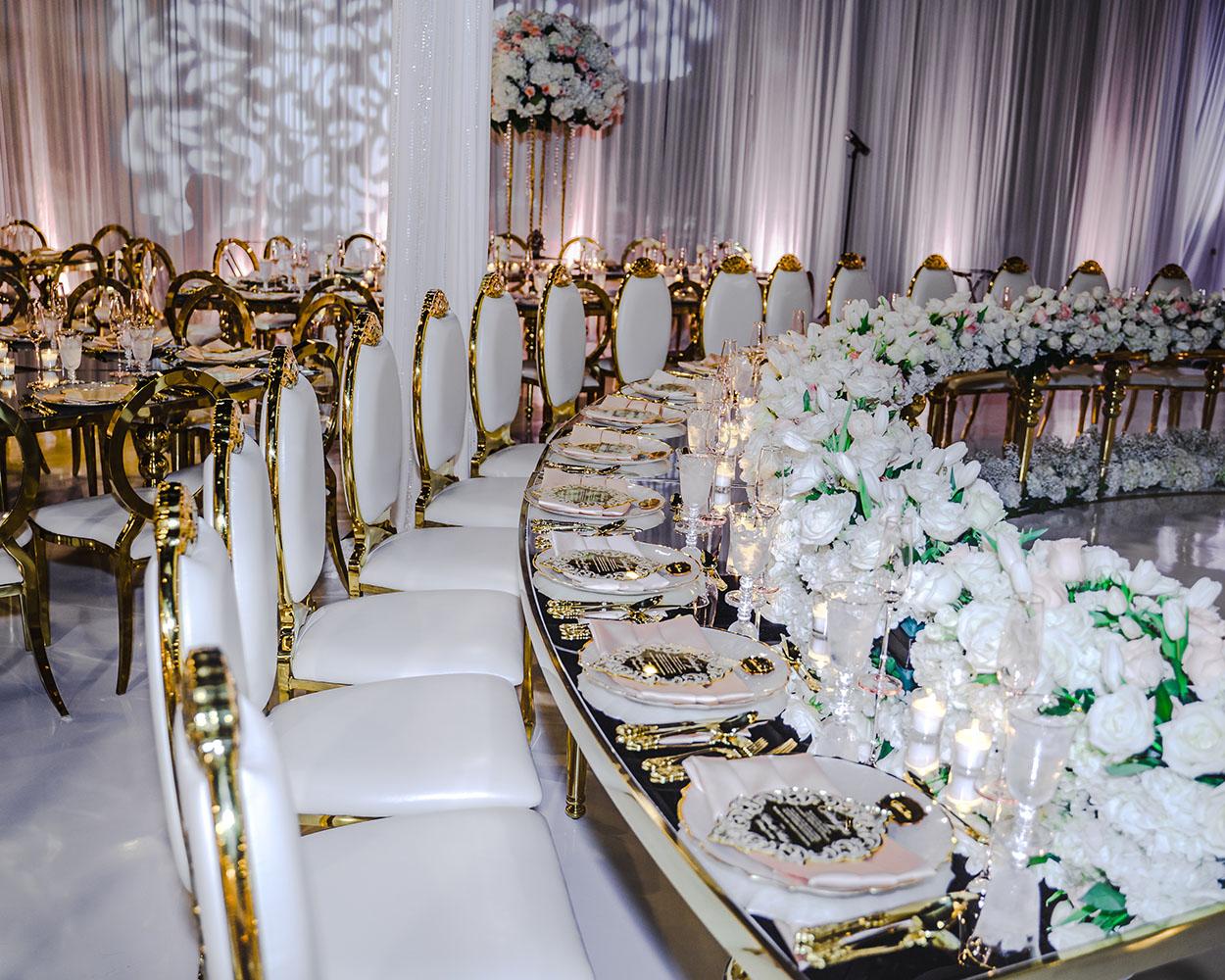 ceiling decor, cake drop, royal luxury, wedding reception decor, gold chairs, mirror tables, chargers, tableware, circle arch