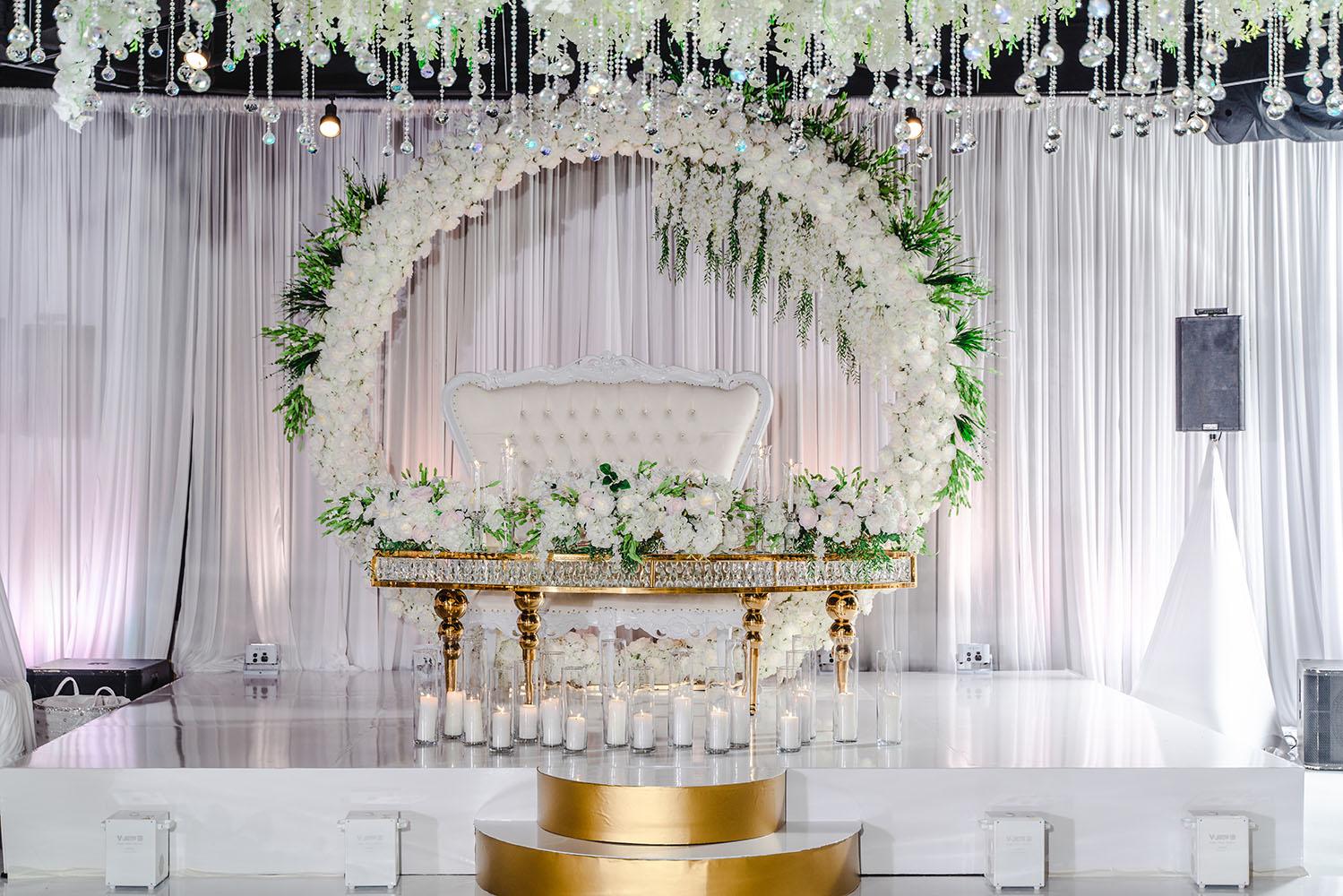 ceiling decor, cake drop, royal luxury, wedding reception decor, gold chairs, mirror tables, chargers, tableware, circle arch