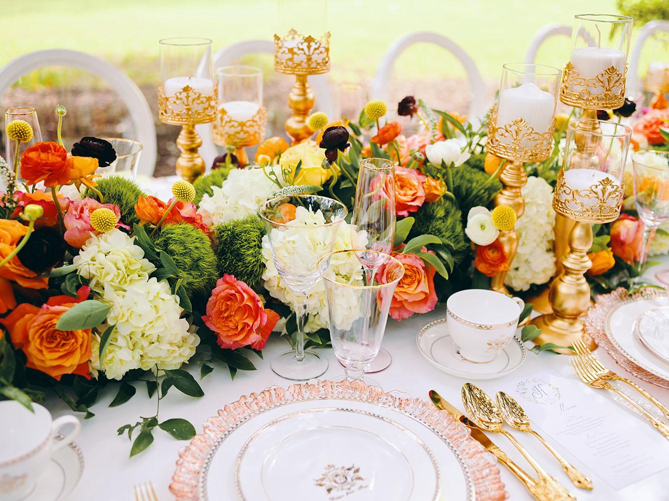 outdoor wedding reception - white chairs - pink napkins, charger plates, gold tableware, floral table runner, wedding cake, pink, yellow, orange, bouquet, houstonian, royal luxury events