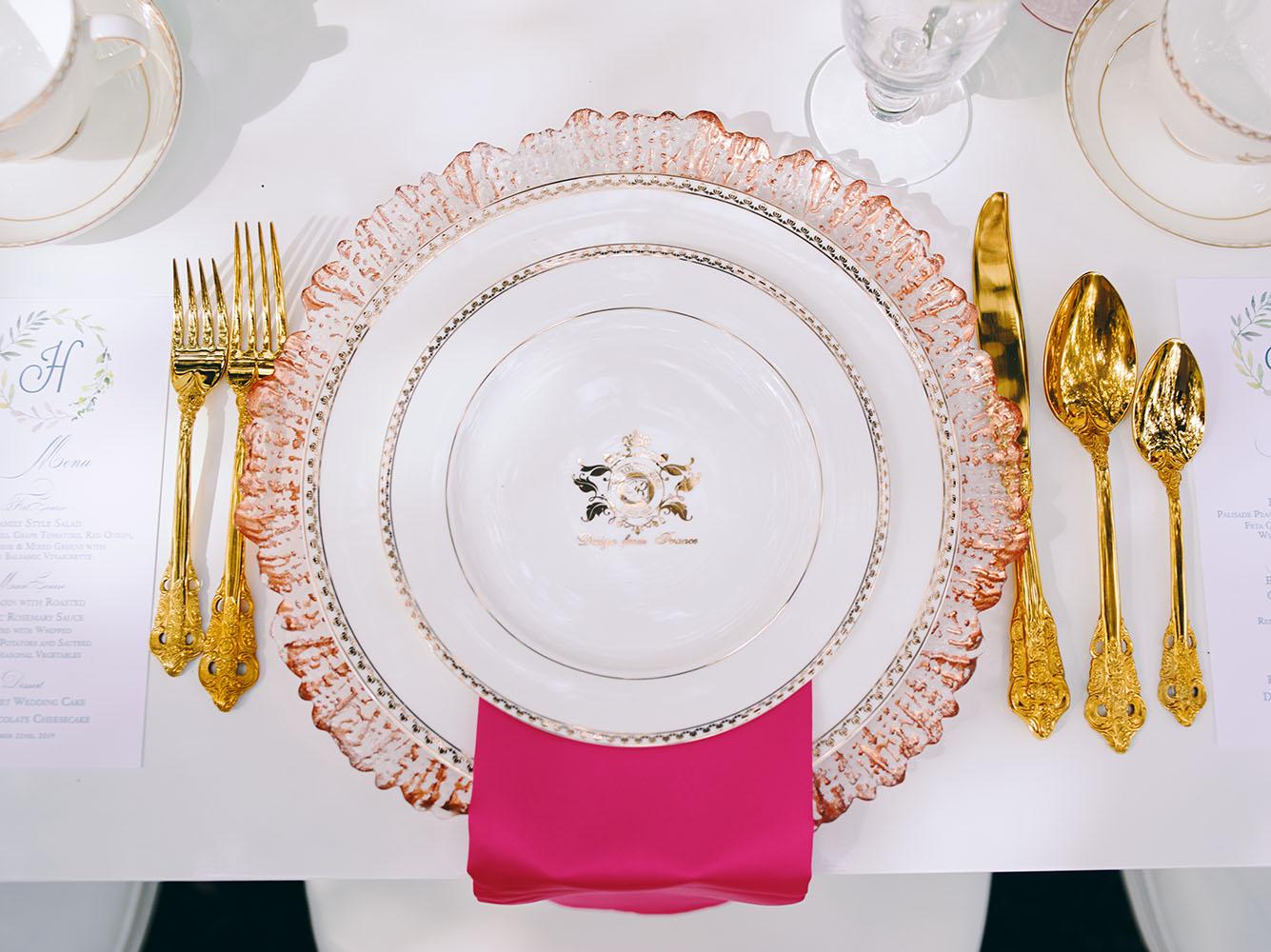 outdoor wedding reception - white chairs - pink napkins, charger plates, gold tableware, floral table runner, wedding cake, pink, yellow, orange, bouquet, houstonian, royal luxury events