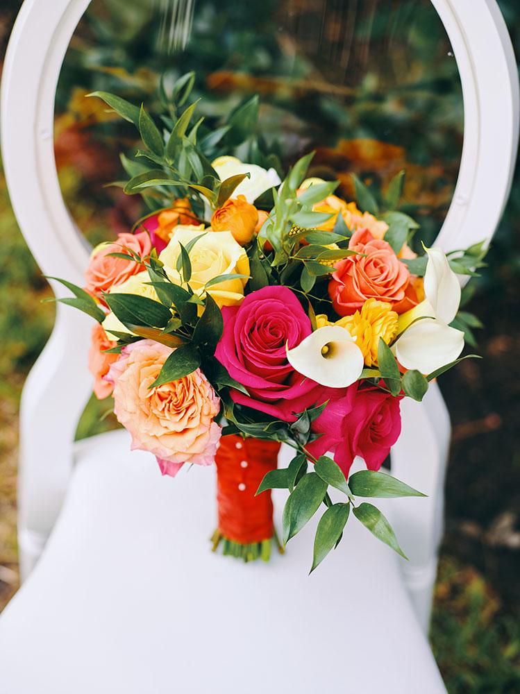 outdoor wedding reception - white chairs - pink napkins, charger plates, gold tableware, floral table runner, wedding cake, pink, yellow, orange, bouquet, houstonian, royal luxury events