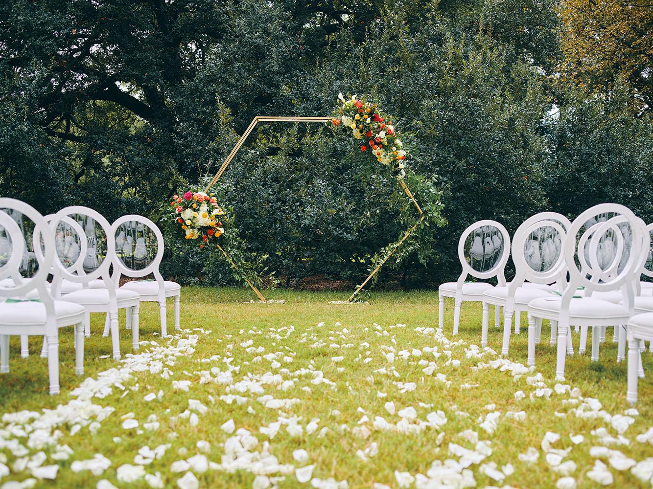outdoor wedding ceremony - hexagon arch - bright florals - white chairs - houstonian hotel