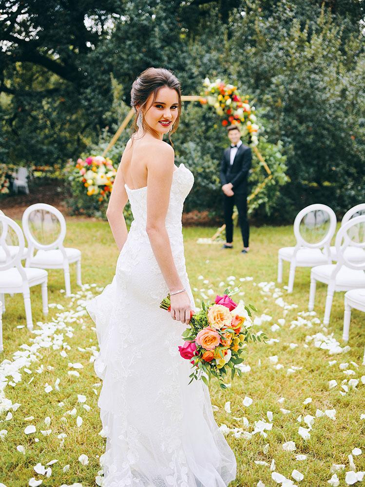 outdoor wedding ceremony - hexagon arch - bright florals - white chairs - houstonian hotel