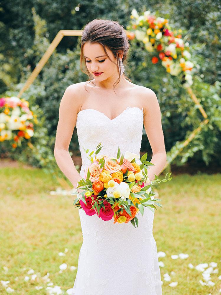 outdoor wedding ceremony - hexagon arch - bright florals - white chairs - houstonian hotel