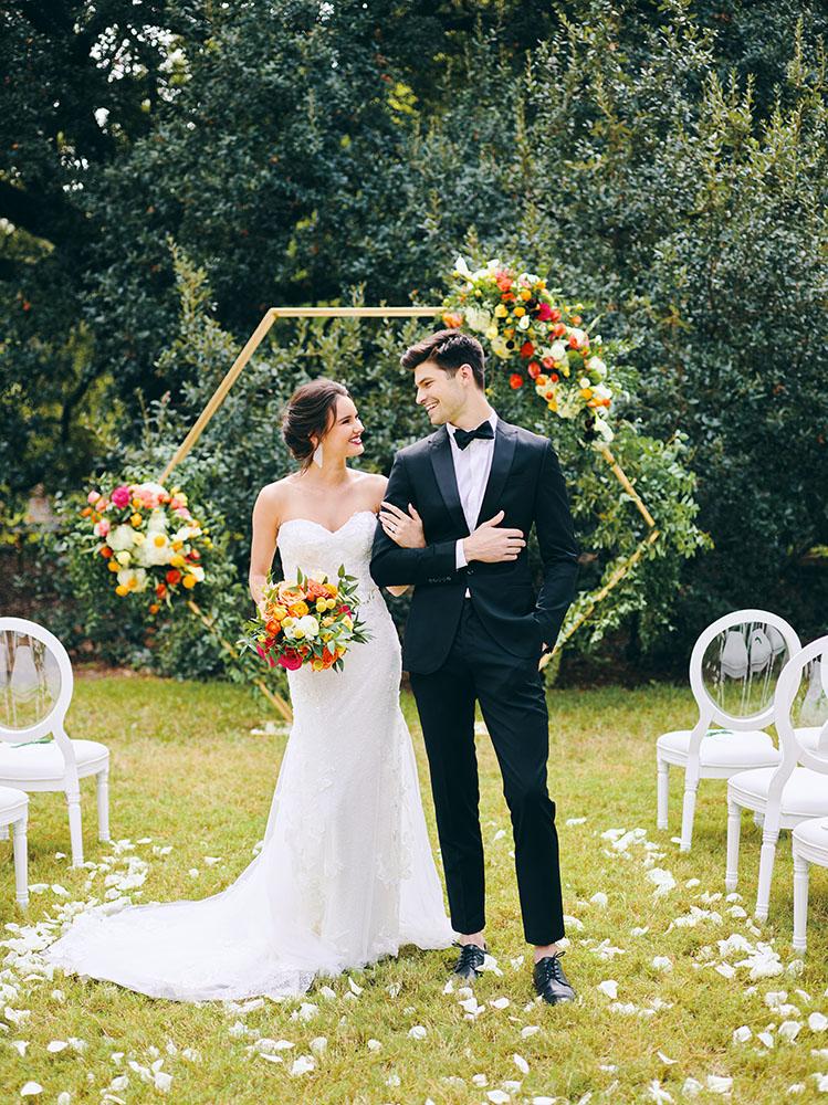 outdoor wedding ceremony - hexagon arch - bright florals - white chairs - houstonian hotel