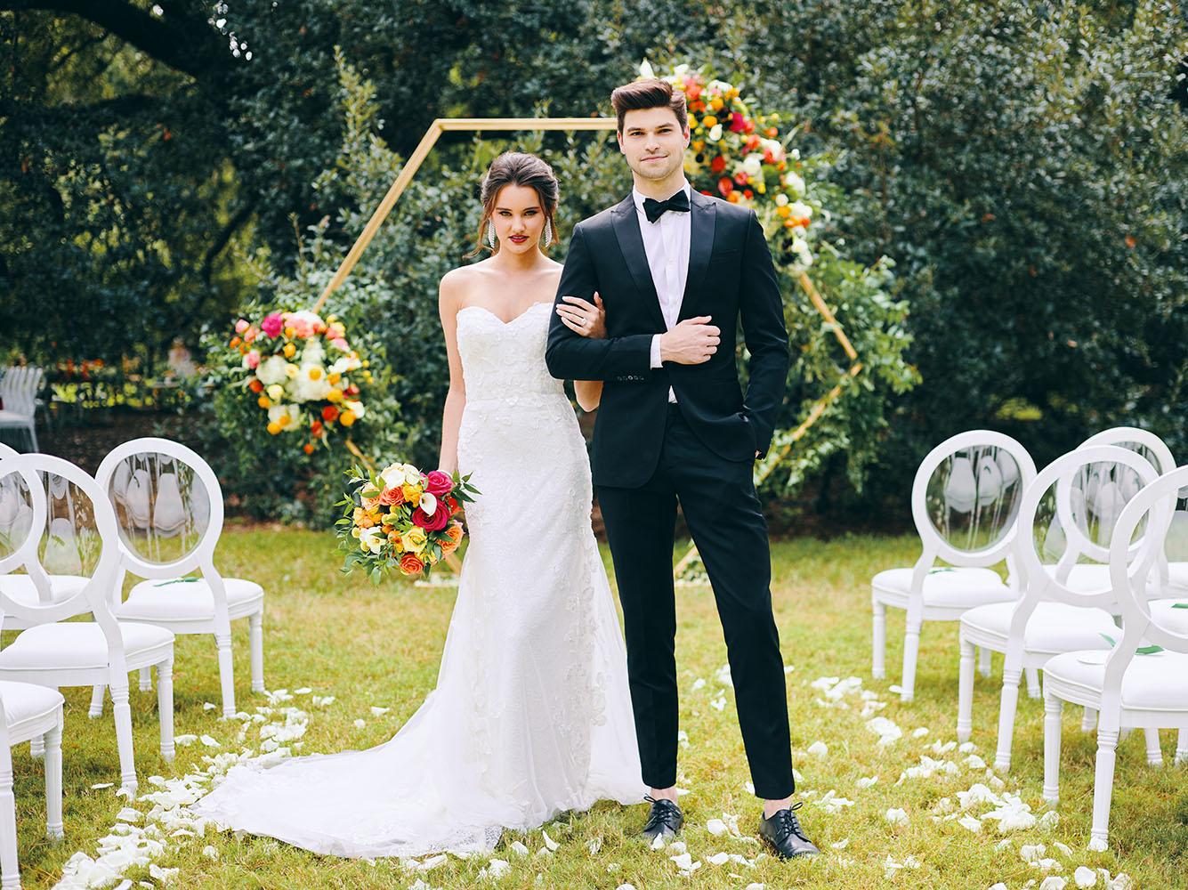 outdoor wedding ceremony - hexagon arch - bright florals - white chairs - houstonian hotel