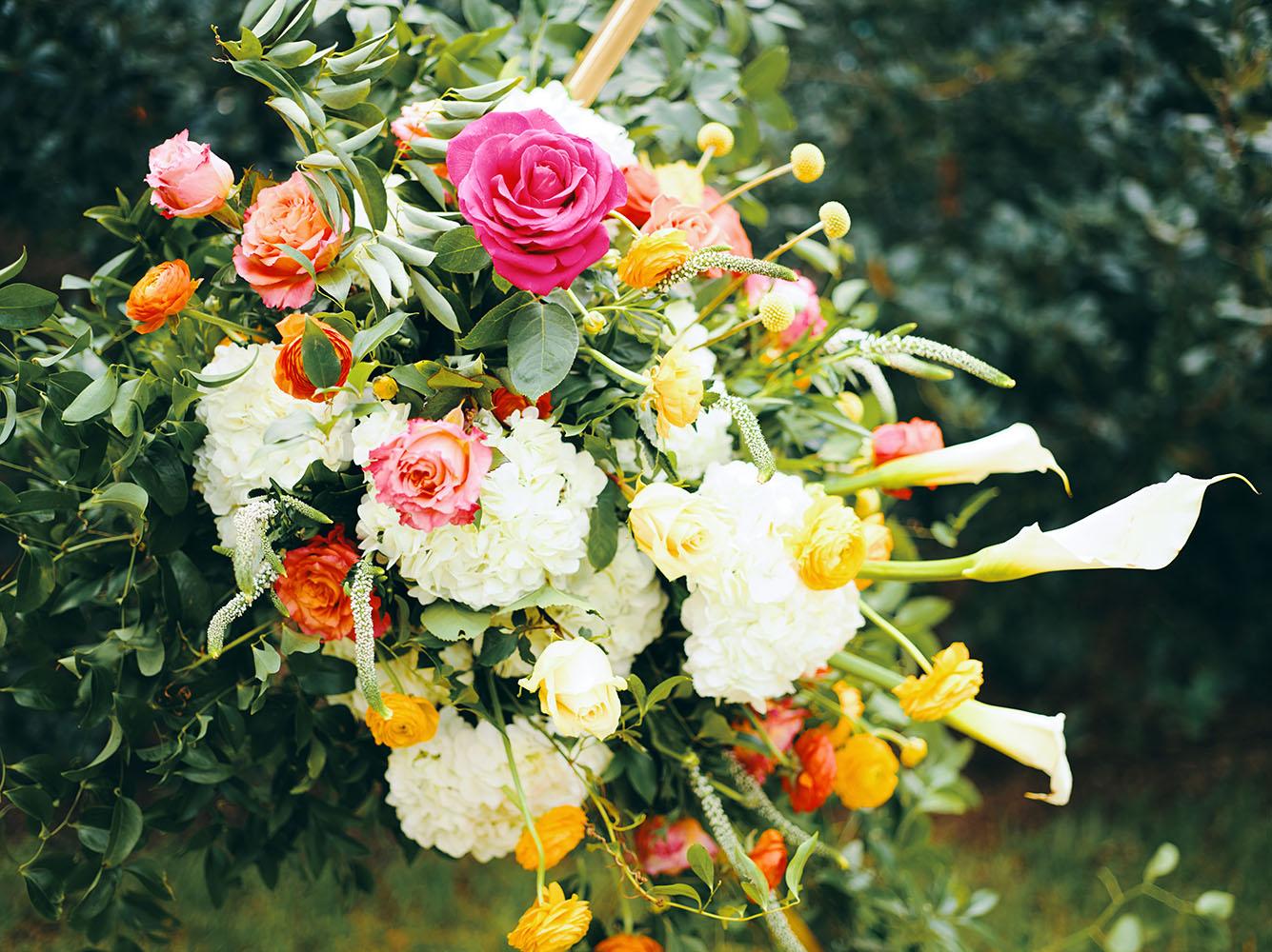 outdoor wedding ceremony - hexagon arch - bright florals - white chairs - houstonian hotel