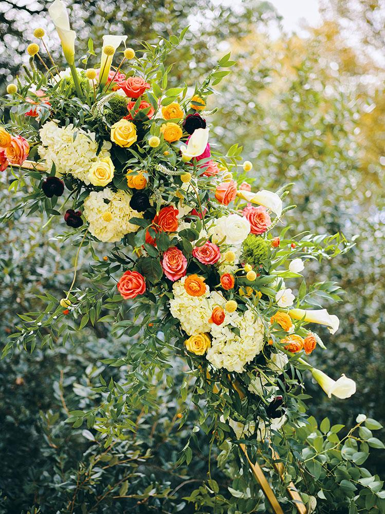 outdoor wedding ceremony - hexagon arch - bright florals - white chairs - houstonian hotel