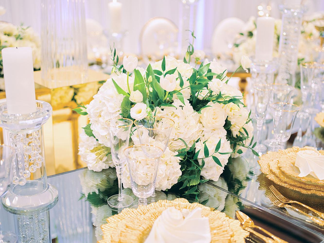 indoor wedding reception decor, white gold, wedding cake, gold chargers, mirror teardrop tables, centerpieces, florist, houstonian, luxury wedding in houston