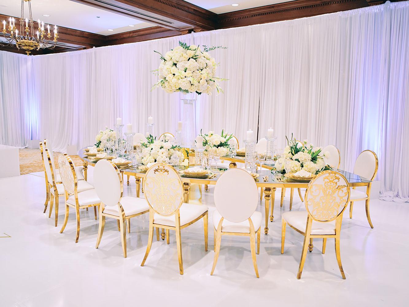 indoor wedding reception decor, white gold, wedding cake, gold chargers, mirror teardrop tables, centerpieces, florist, houstonian, luxury wedding in houston