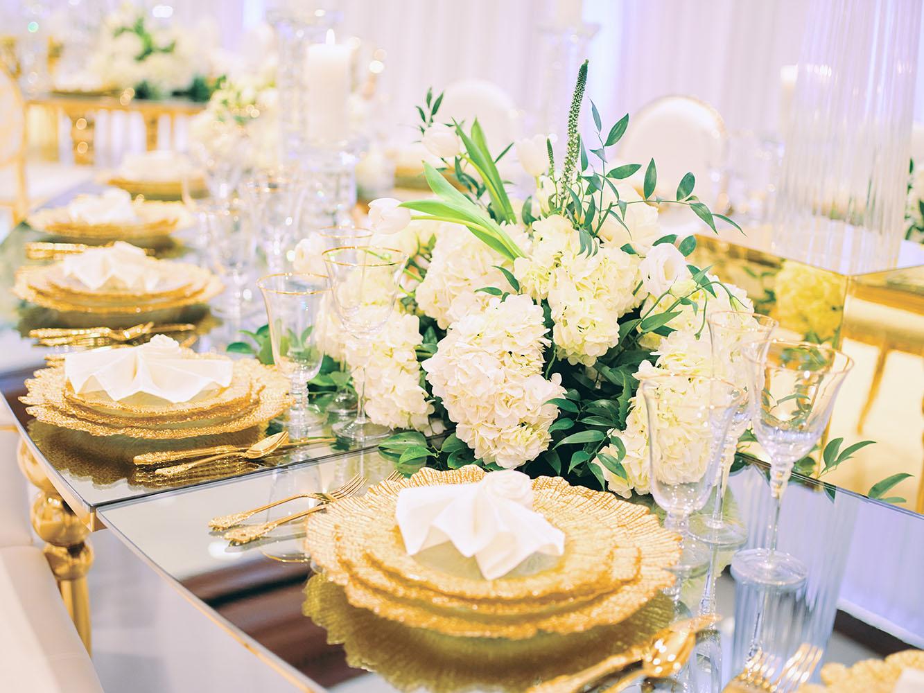 indoor wedding reception decor, white gold, wedding cake, gold chargers, mirror teardrop tables, centerpieces, florist, houstonian, luxury wedding in houston