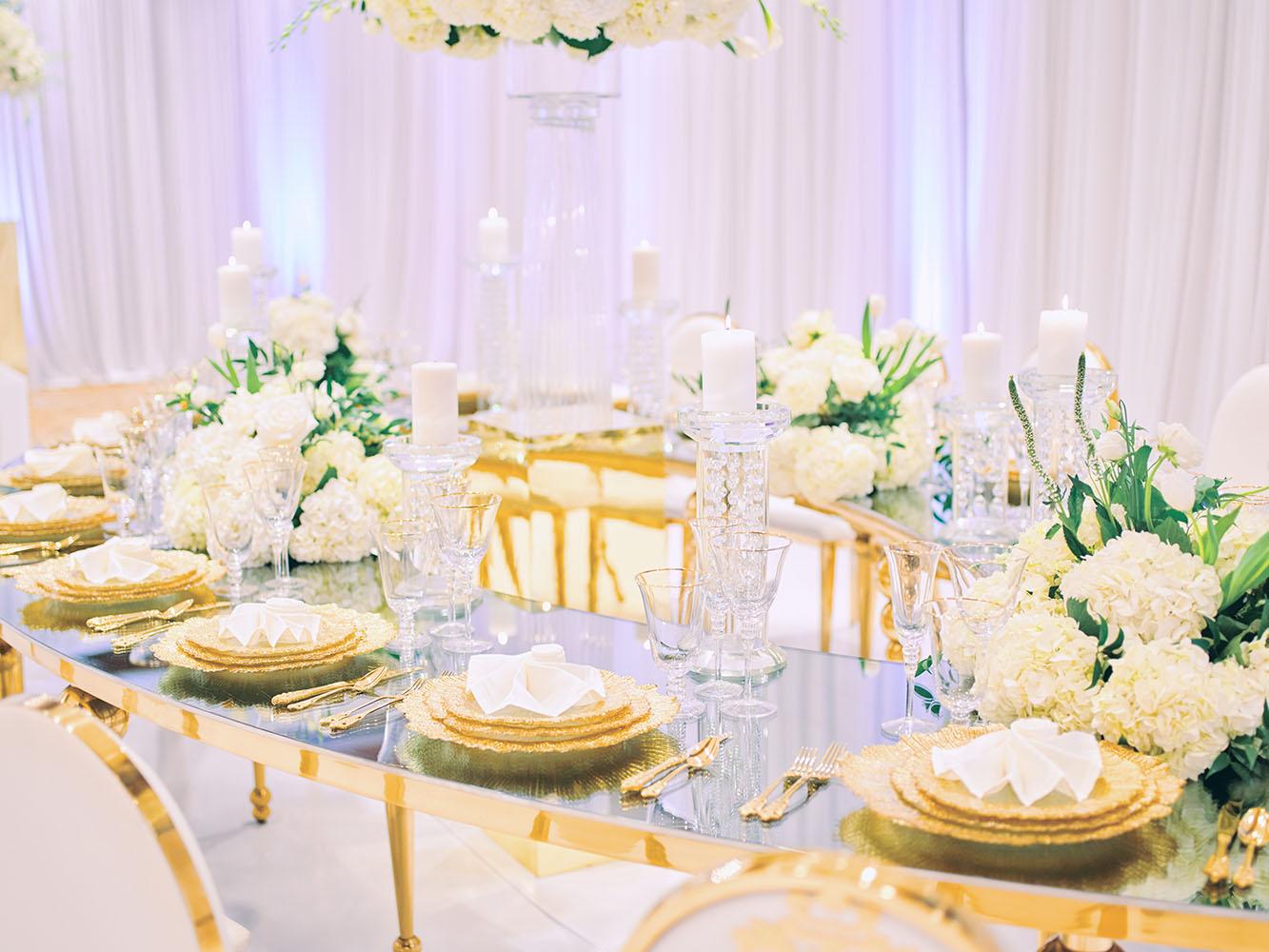 indoor wedding reception decor, white gold, wedding cake, gold chargers, mirror teardrop tables, centerpieces, florist, houstonian, luxury wedding in houston