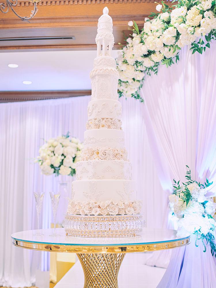 indoor wedding reception decor, white gold, wedding cake, gold chargers, mirror teardrop tables, centerpieces, florist, houstonian, luxury wedding in houston