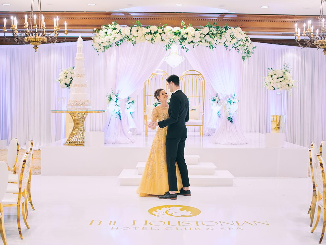 indoor wedding reception decor, white gold, wedding cake, gold chargers, mirror teardrop tables, centerpieces, florist, houstonian, luxury wedding in houston