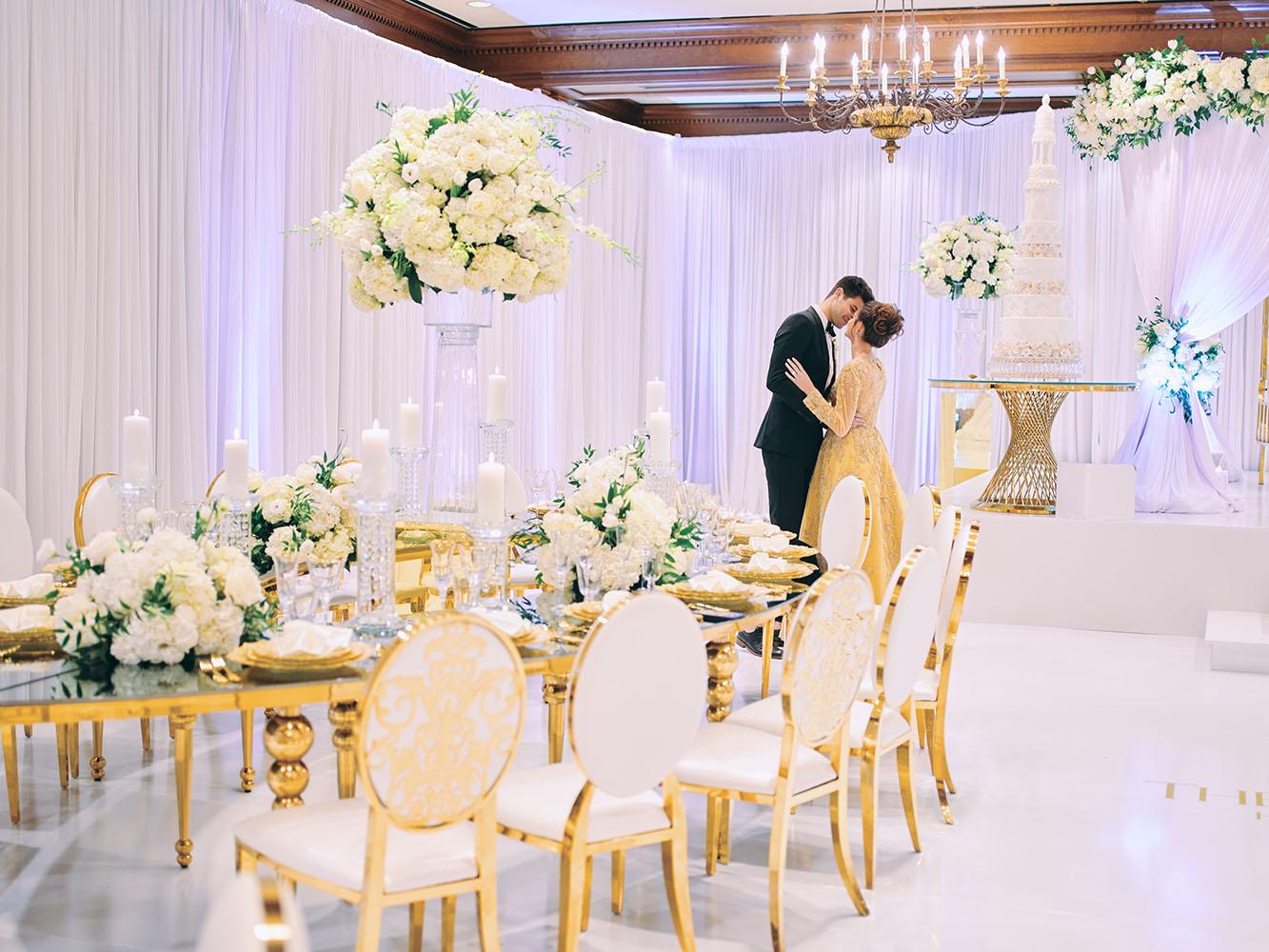 indoor wedding reception decor, white gold, wedding cake, gold chargers, mirror teardrop tables, centerpieces, florist, houstonian, luxury wedding in houston