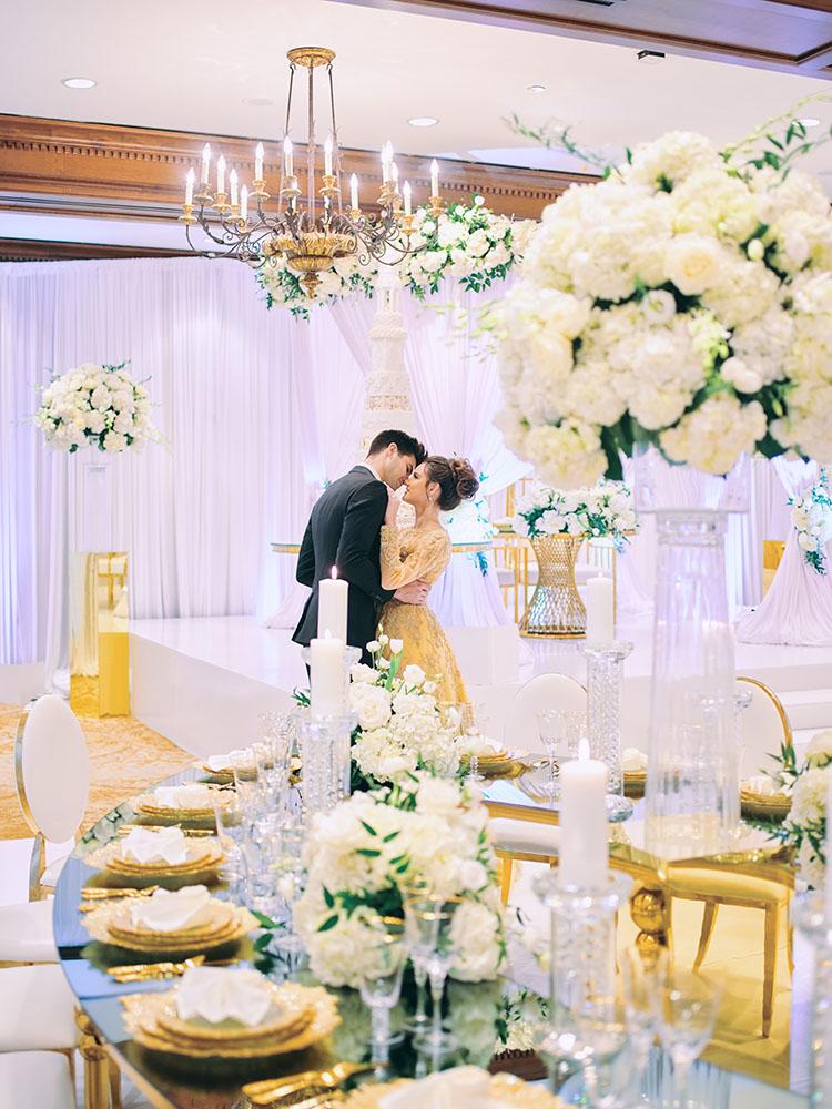 indoor wedding reception decor, white gold, wedding cake, gold chargers, mirror teardrop tables, centerpieces, florist, houstonian, luxury wedding in houston