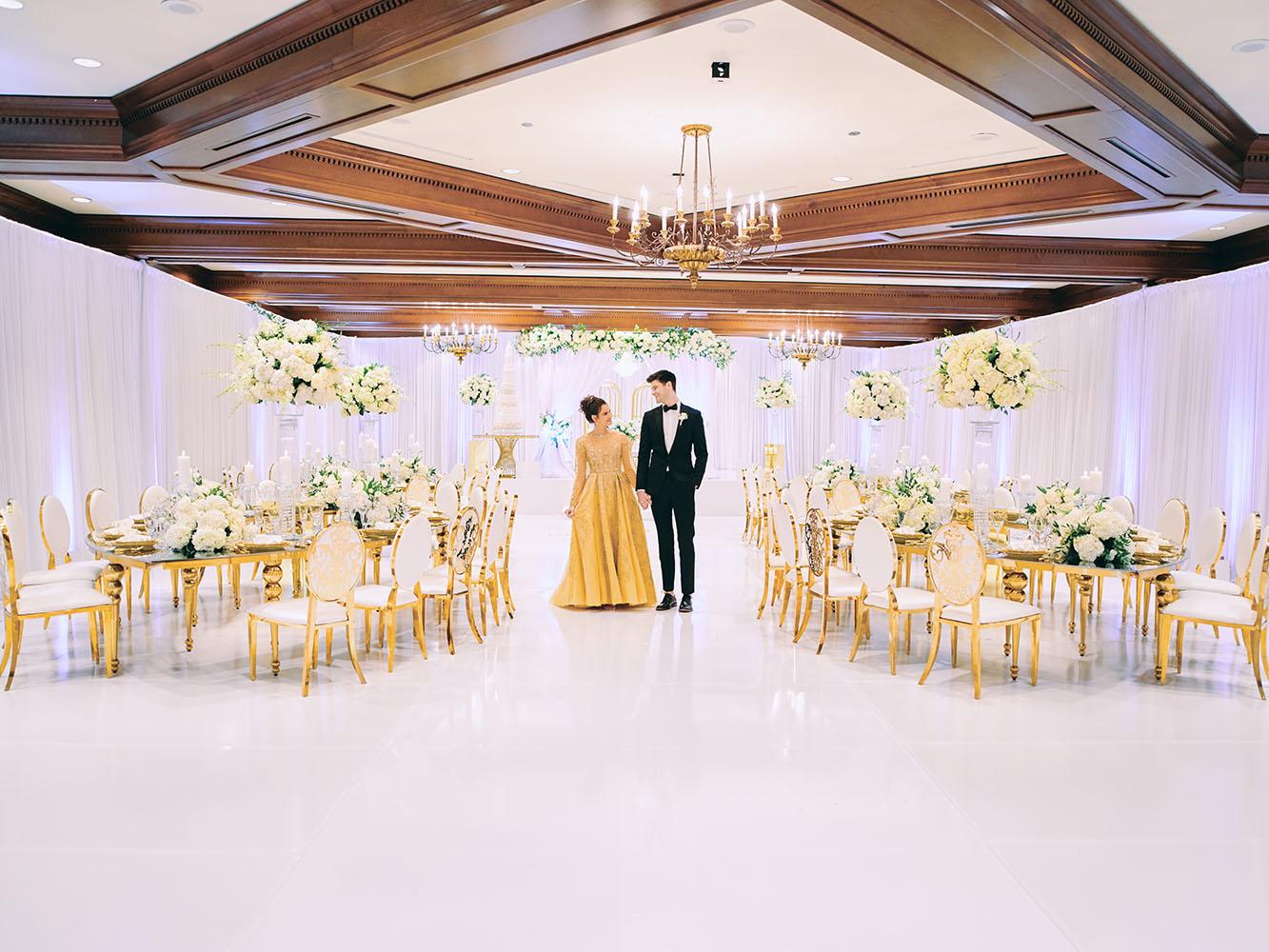 indoor wedding reception decor, white gold, wedding cake, gold chargers, mirror teardrop tables, centerpieces, florist, houstonian, luxury wedding in houston