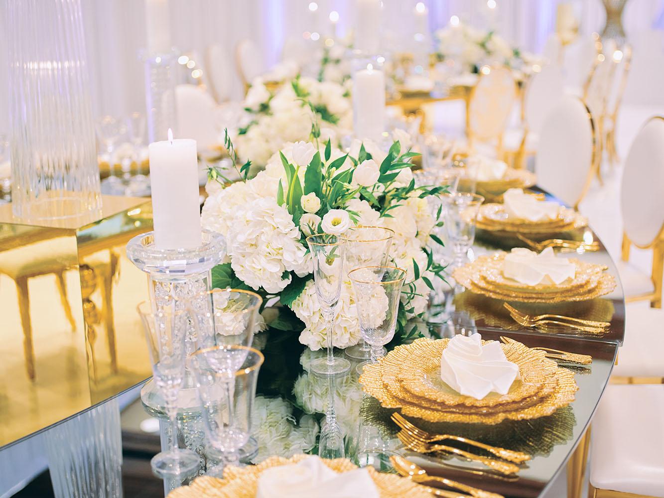 indoor wedding reception decor, white gold, wedding cake, gold chargers, mirror teardrop tables, centerpieces, florist, houstonian, luxury wedding in houston