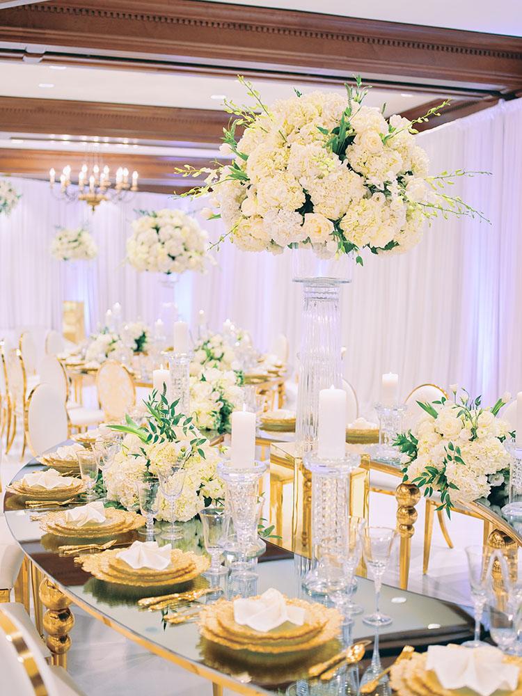indoor wedding reception decor, white gold, wedding cake, gold chargers, mirror teardrop tables, centerpieces, florist, houstonian, luxury wedding in houston