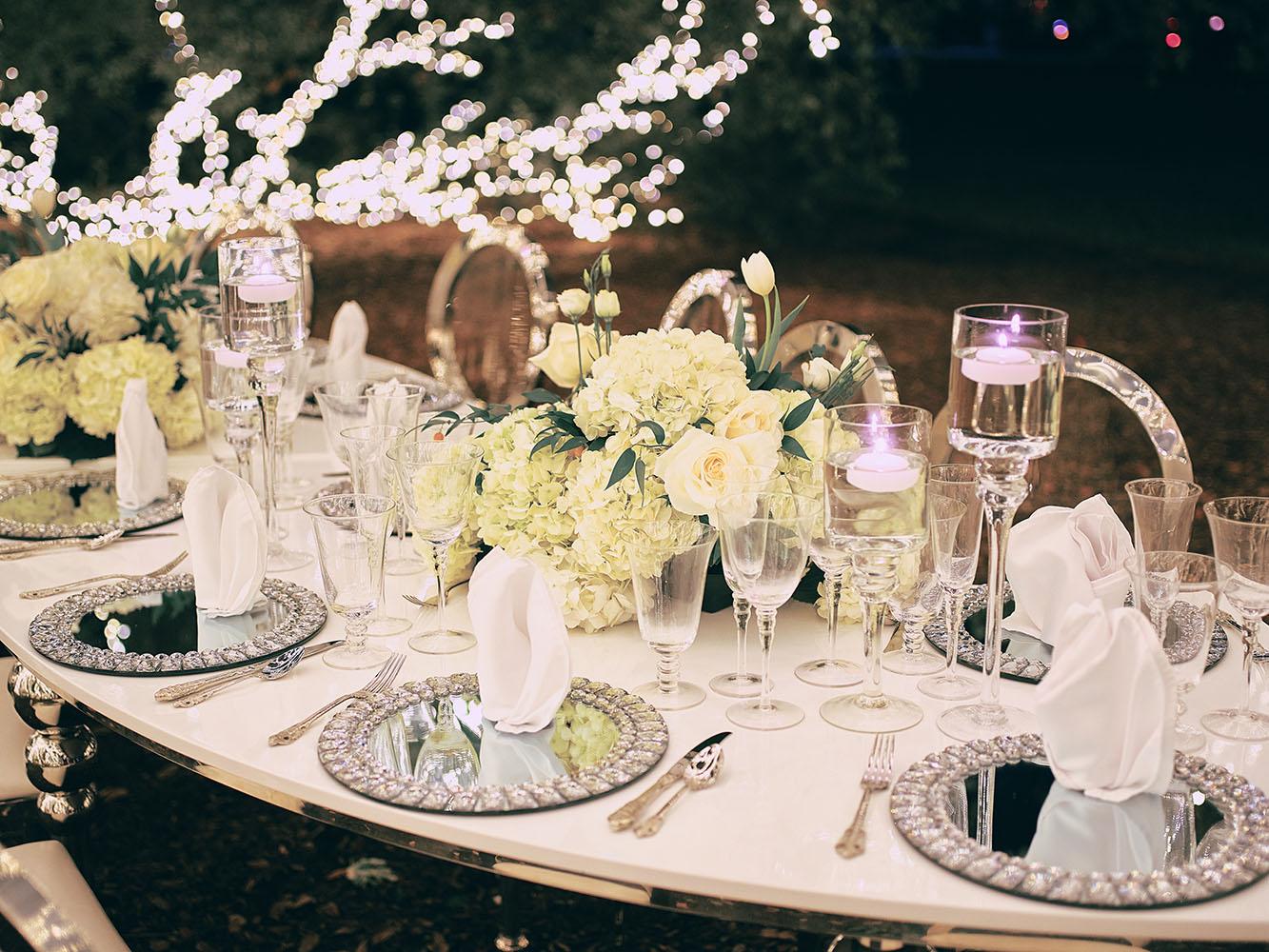 outdoor night wedding reception decor - serpentine table - silver - lights - houstonian - luxury houston wedding