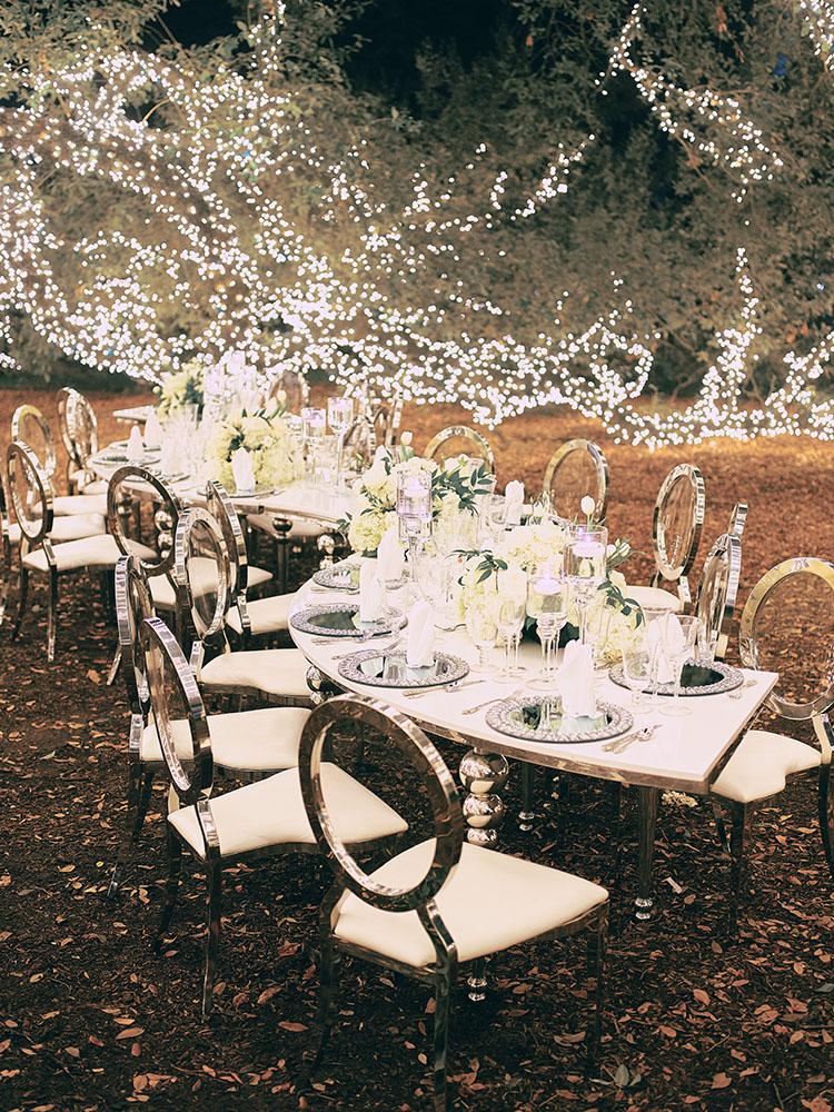 outdoor night wedding reception decor - serpentine table - silver - lights - houstonian - luxury houston wedding
