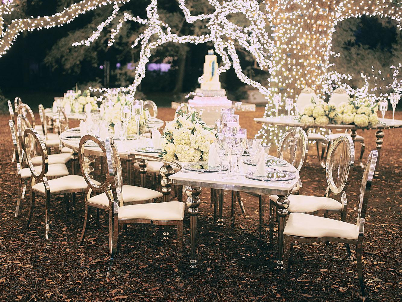 outdoor night wedding reception decor - serpentine table - silver - lights - houstonian - luxury houston wedding