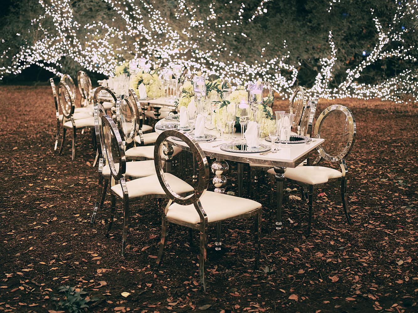 outdoor night wedding reception decor - serpentine table - silver - lights - houstonian - luxury houston wedding