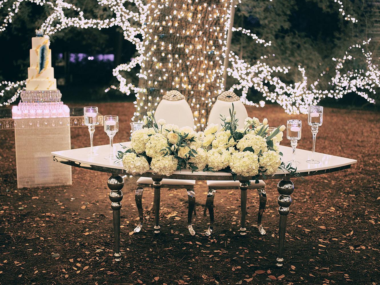 outdoor night wedding reception decor - serpentine table - silver - lights - houstonian - luxury houston wedding