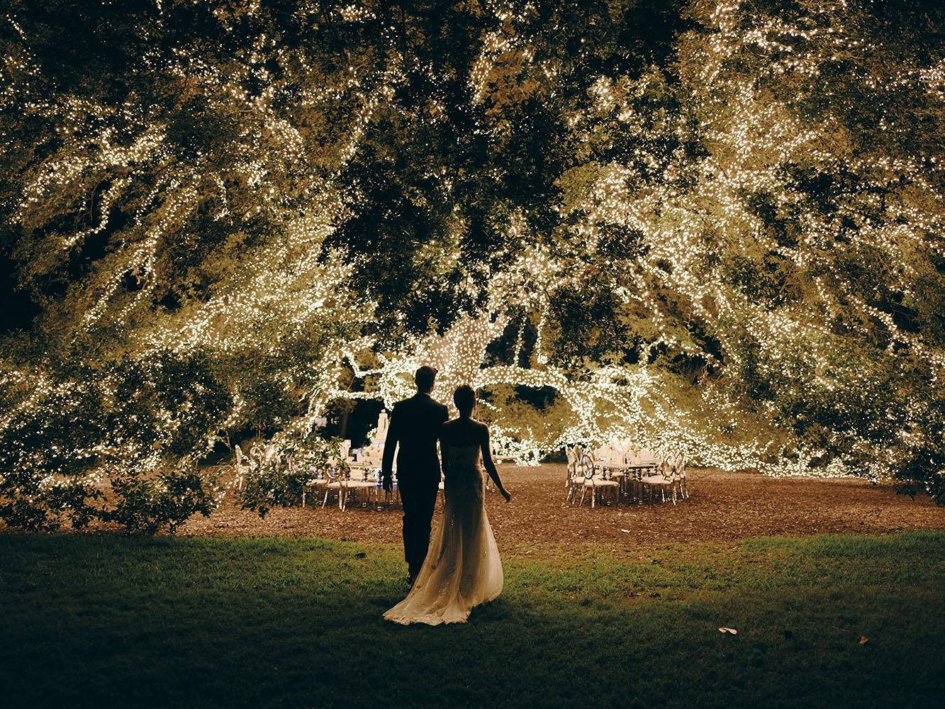 outdoor night wedding reception decor - serpentine table - silver - lights - houstonian - luxury houston wedding