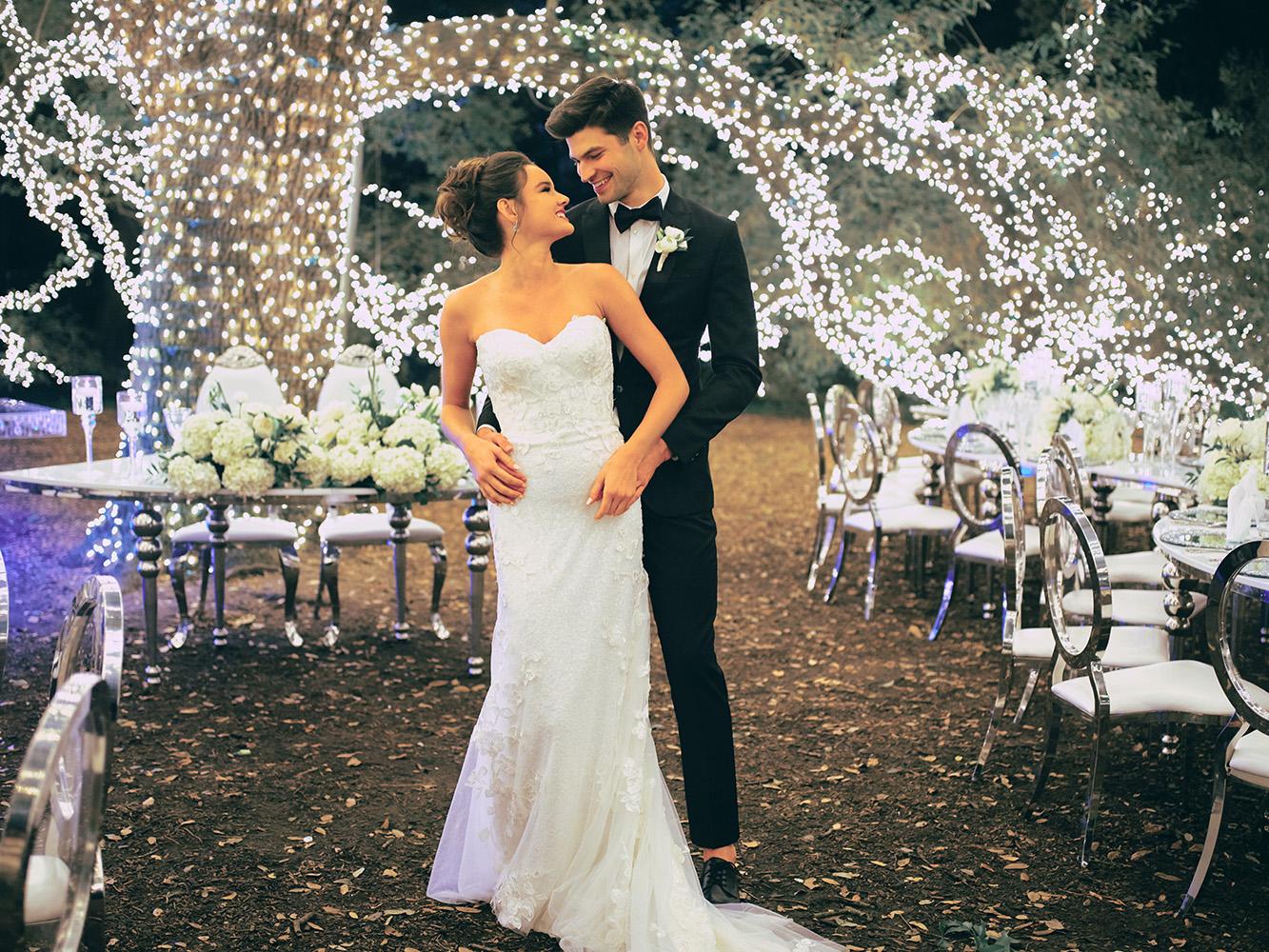 outdoor night wedding reception decor - serpentine table - silver - lights - houstonian - luxury houston wedding