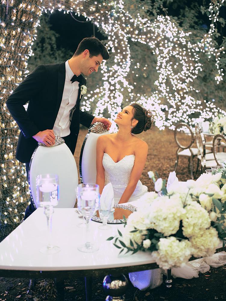 outdoor night wedding reception decor - serpentine table - silver - lights - houstonian - luxury houston wedding