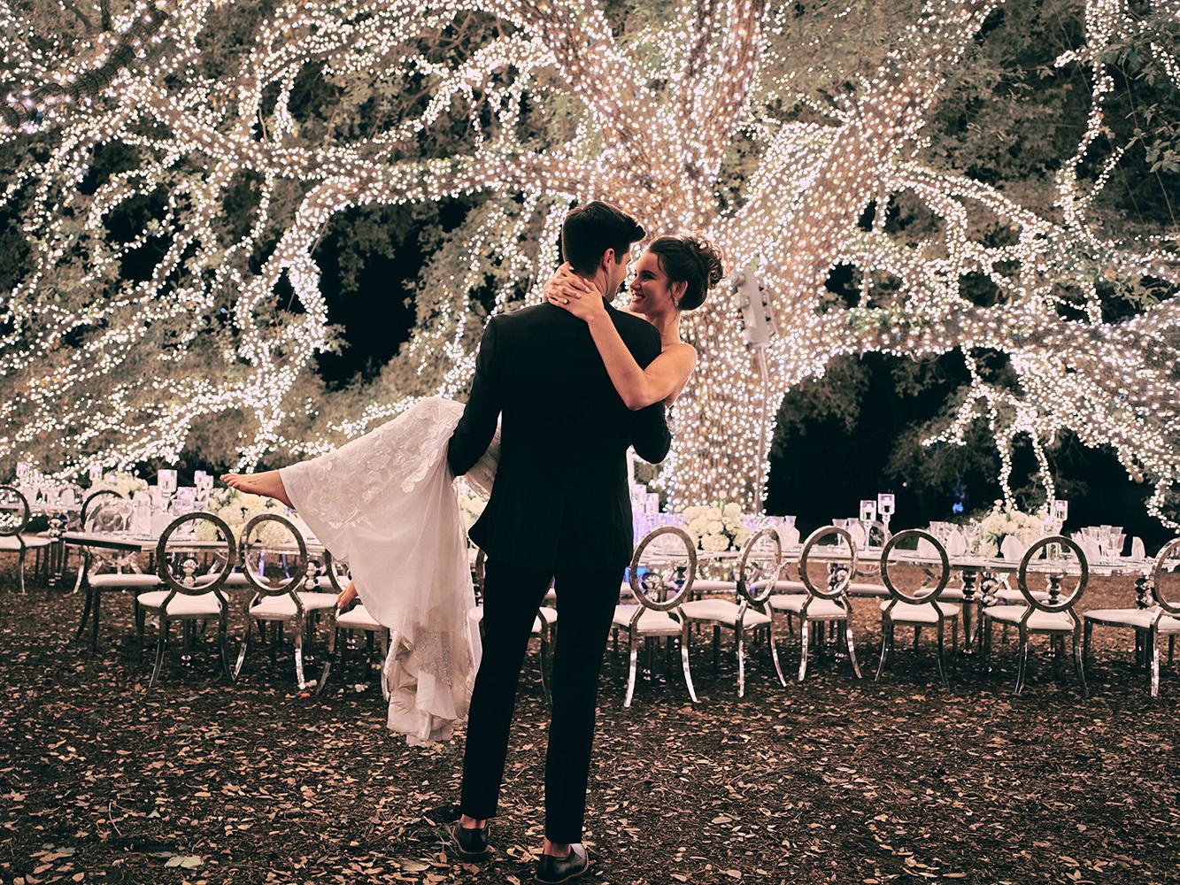 outdoor night wedding reception decor - serpentine table - silver - lights - houstonian - luxury houston wedding