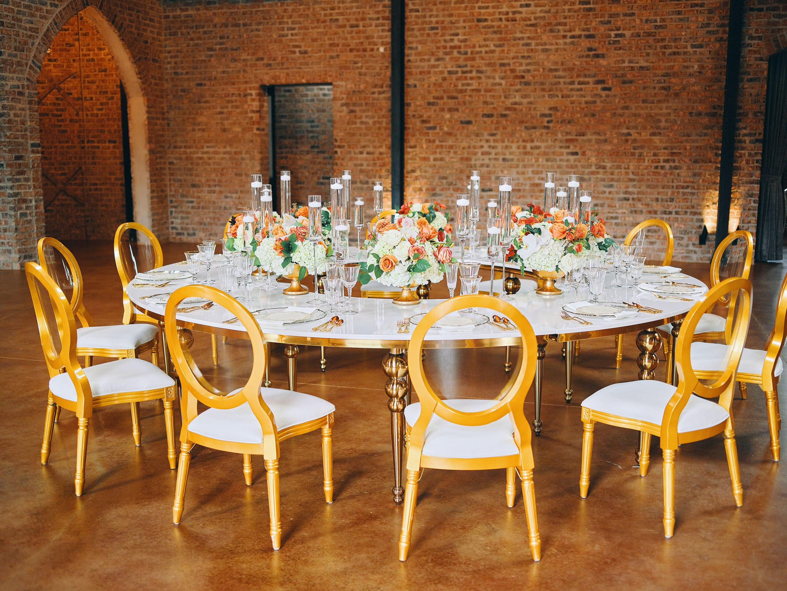 luxurious indoor wedding reception decor - gold luxury chairs