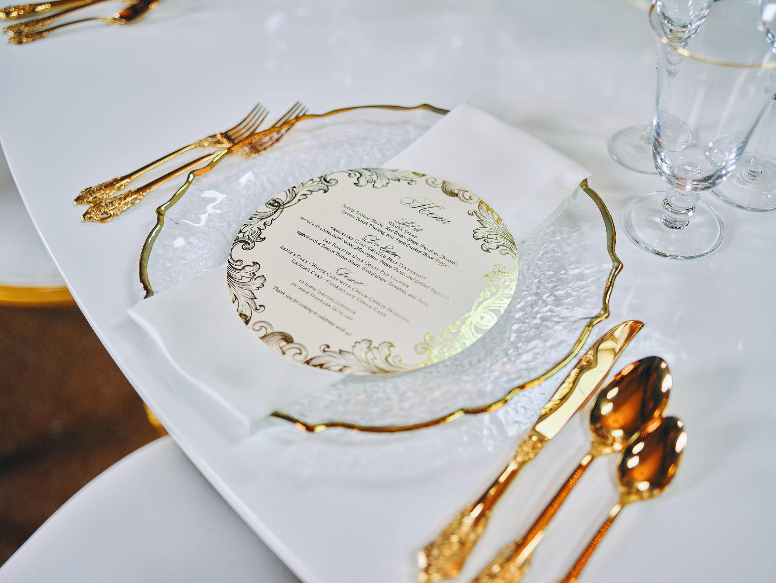 luxurious indoor wedding reception decor - gold luxury chairs - charger plates
