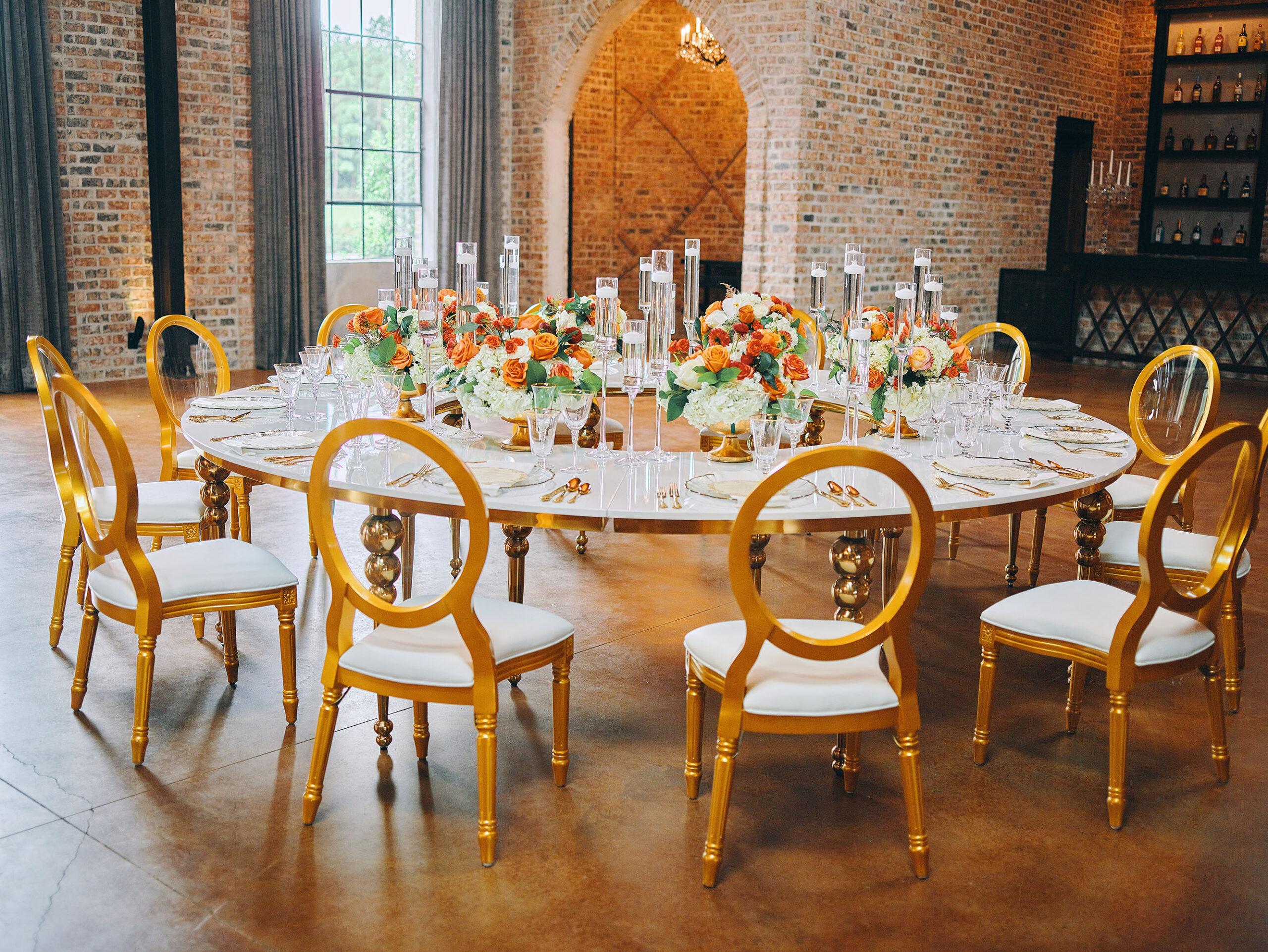 luxurious indoor wedding reception decor - gold luxury chairs - round table