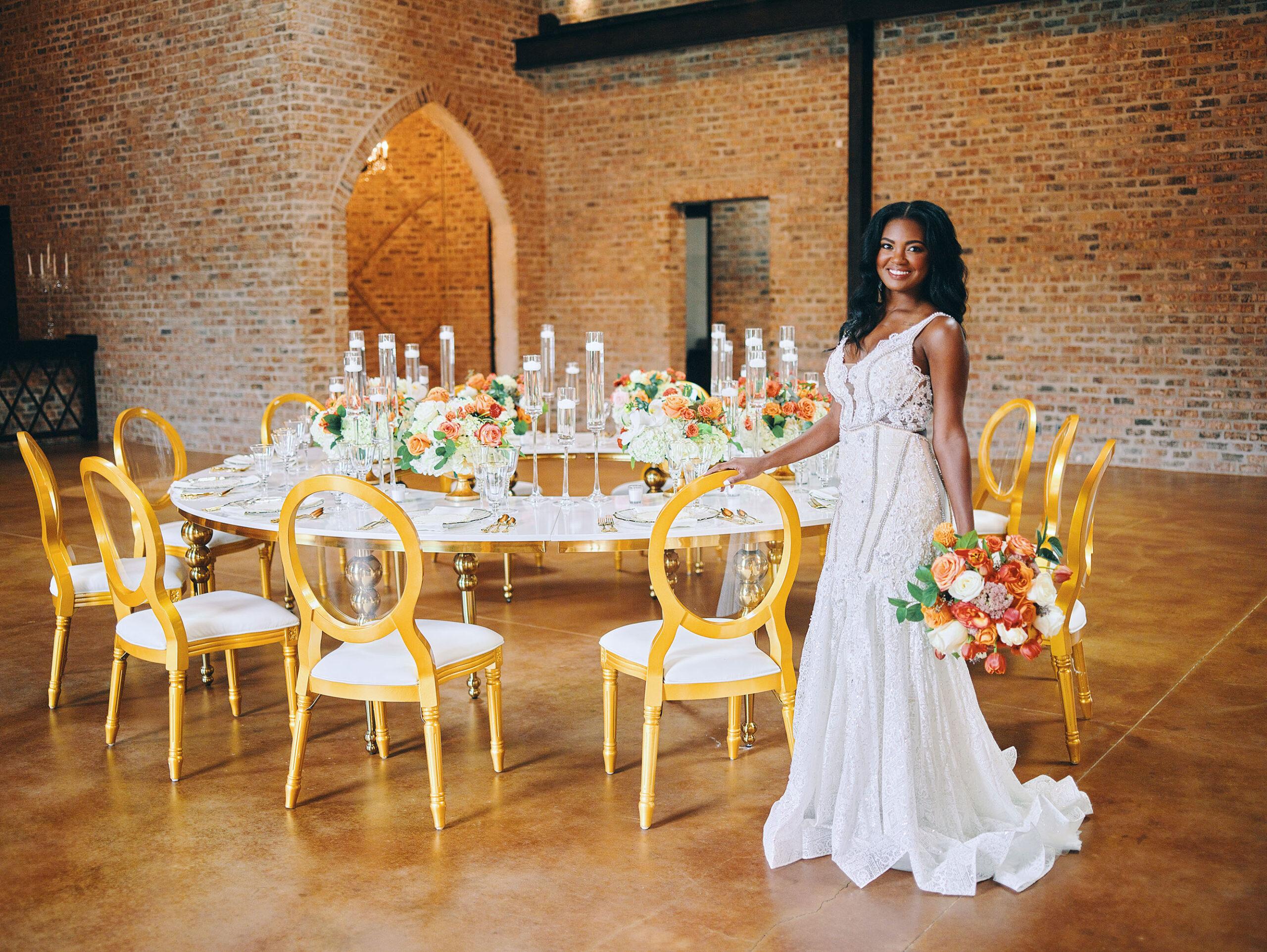 luxurious indoor wedding reception decor - gold luxury chairs - round table