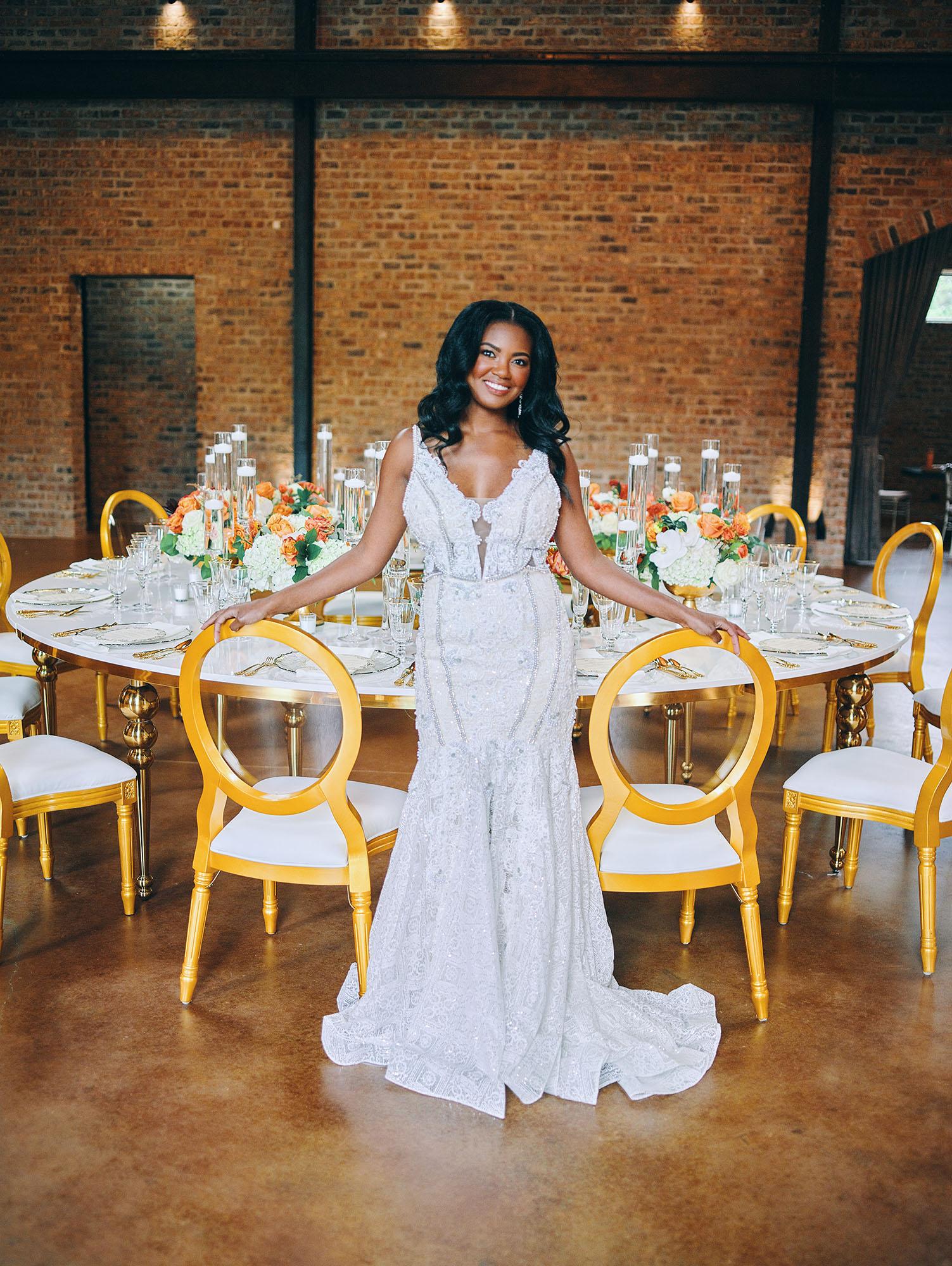 luxurious indoor wedding reception decor - gold luxury chairs - round table
