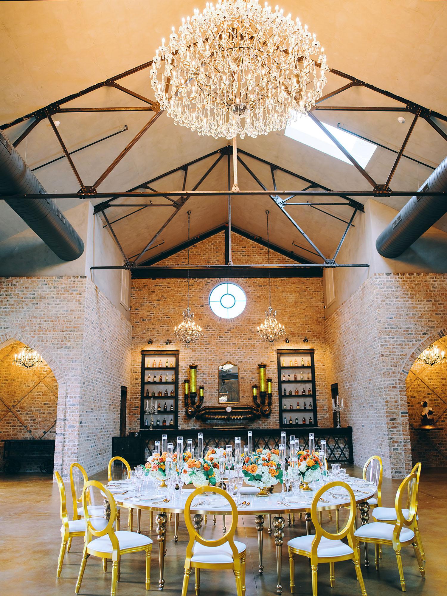 luxurious indoor wedding reception decor - gold luxury chairs - round table